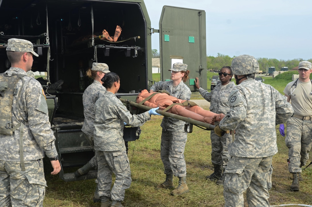 U.S. Army Reserve Soldiers, assigned to the 469th Medical Company-Ground Ambulance out of Wichita, Kansas, and Air Men, assigned to the 6th Medical Operations Squadron out of MacDill Air Force Base in Tampa, Fl., transport casualties from the point of drop off to the Air Force expeditionary medical support tent at forward operating base Nighthawk in Camp Atterbury, In., April 29, 2017, as part of Exercise Guardian Response. Nearly 4,100 Soldiers from across the country are participating in Guardian Response 17, a multi-component training exercise to validate U.S. Army units’ ability to support the Defense Support of Civil Authorities (DSCA) in the event of a Chemical, Biological, Radiological, and Nuclear (CBRN) catastrophe. The 84th Training Command is the hosting organization for this exercise, with the training operations run by the 78th Training Division, headquartered in Fort Dix, New Jersey. (U.S. Army Reserve photo by Staff Sgt. Christopher Sofia)