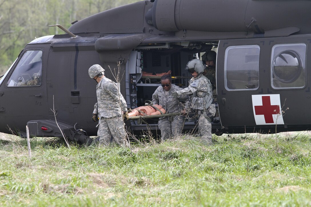 U.S. Army Reserve Soldiers, assigned to the 469th Medical Company-Ground Ambulance out of Wichita, Kansas, and Air Men, assigned to the 6th Medical Operations Squadron out of MacDill Air Force Base in Tampa, Fl., transport casualties from the point of drop off to the Air Force expeditionary medical support tent at forward operating base Nighthawk in Camp Atterbury, In., April 29, 2017, as part of Exercise Guardian Response. Nearly 4,100 Soldiers from across the country are participating in Guardian Response 17, a multi-component training exercise to validate U.S. Army units’ ability to support the Defense Support of Civil Authorities (DSCA) in the event of a Chemical, Biological, Radiological, and Nuclear (CBRN) catastrophe. The 84th Training Command is the hosting organization for this exercise, with the training operations run by the 78th Training Division, headquartered in Fort Dix, New Jersey. (U.S. Army Reserve photo by Staff Sgt. Christopher Sofia)