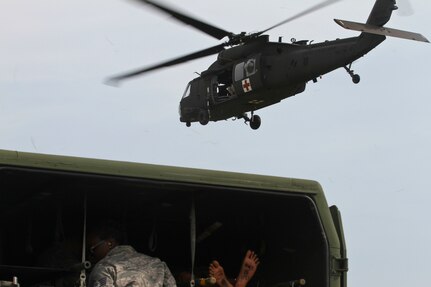 U.S. Army Reserve Soldiers, assigned to the 469th Medical Company-Ground Ambulance out of Wichita, Kansas, and Air Men, assigned to the 6th Medical Operations Squadron out of MacDill Air Force Base in Tampa, Fl., transport casualties from the point of drop off to the Air Force expeditionary medical support tent at forward operating base Nighthawk in Camp Atterbury, In., April 29, 2017, as part of Exercise Guardian Response. Nearly 4,100 Soldiers from across the country are participating in Guardian Response 17, a multi-component training exercise to validate U.S. Army units’ ability to support the Defense Support of Civil Authorities (DSCA) in the event of a Chemical, Biological, Radiological, and Nuclear (CBRN) catastrophe. The 84th Training Command is the hosting organization for this exercise, with the training operations run by the 78th Training Division, headquartered in Fort Dix, New Jersey. (U.S. Army Reserve photo by Staff Sgt. Christopher Sofia)