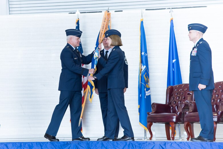 Maj. Gen. John P. Stokes, 22nd Air Force commander, passes the 403rd Wing guidon to Col. Jennie R. Johnson, incoming 403rd Wing commander, during the 403rd Wing change of command ceremony May 7, 2017 at Keesler Air Force Base, Mississippi. (U.S. Air Force photo/Staff Sgt. Heather Heiney)