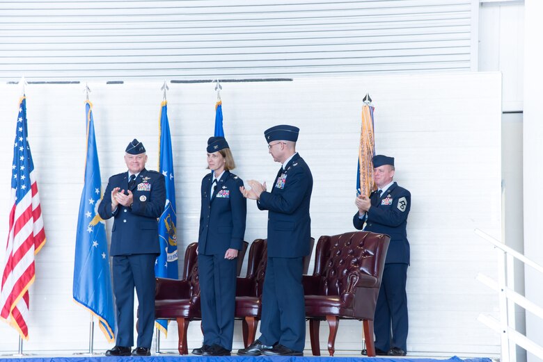 Maj. Gen. John P. Stokes, 22nd Air Force commander and Col. Michael W. Manion, departing 403rd Wing commander, applaud Col. Jennie R. Johnson, incoming 403rd Wing commander, during the 403rd Wing change of command ceremony May 7, 2017 at Keesler Air Force Base, Mississippi. (U.S. Air Force photo/Staff Sgt. Heather Heiney)