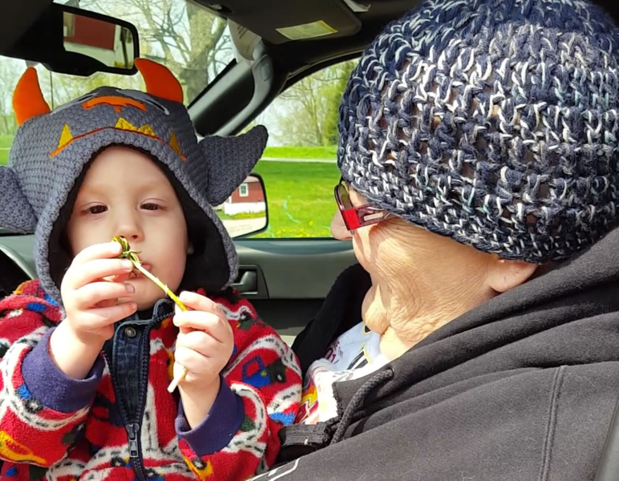 CAMPBELLSPORT, Wis. – Karen Gudex, mother of Senior Airman Rose Gudex, 21st Space Wing Public Affairs photojournalist at Peterson Air Force Base, Colo., smiles as she receives a dandelion from her grandson, Avery, for Mother’s Day in May 2016. Karen passed away Aug. 25, 2016 from lunch cancer. (Courtesy photo)