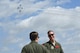 1st Lt. Aaron, pilot, and Tech. Sgt. Christopher, sensor operator both assigned to the 867th Attack Squadron hold a conversation during the 2017 Wings over Solano air show May 6, 2017, at Travis Air Force Base, Calif. The aircrew greeted and discussed facts to all attendees interested in the MQ-9 Reaper model during the show. (U.S. Air Force photo/Airman 1st Class James Thompson)