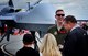 Tech. Sgt. Christopher, 867th Attack Squadron MQ-9 Reaper sensor operator, shares a laugh with spectators of the Wings Over Solano air show May 6, 2017, at Travis Air Force Base, Calif. Interacting with spectators gave MQ-9 crews the opportunity to dispel myths, provide information and explain the reaper mission. (U.S. Air Force photo/Senior Airman Christian Clausen)