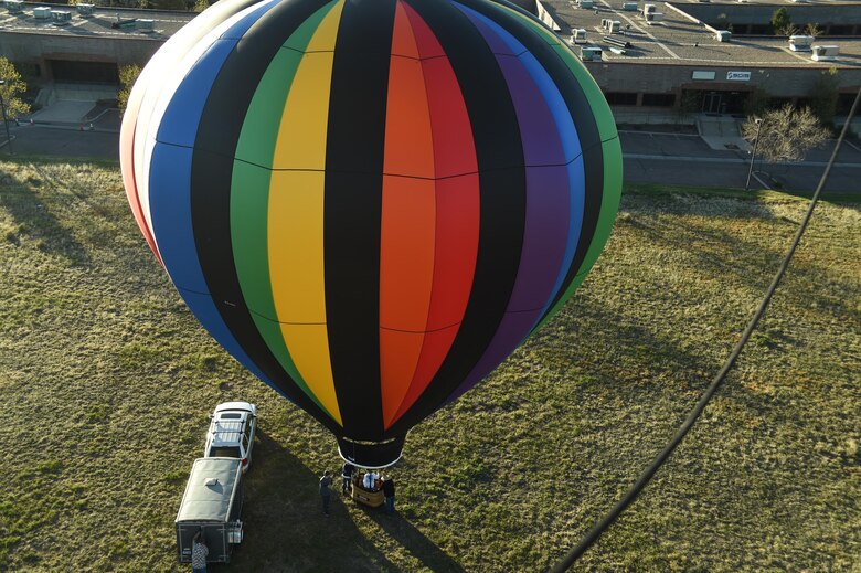 A Schriever Single Airmen’s Initiative group piles into a hot air balloon at Colorado Springs, Colorado, Saturday, May 6, 2017. SAI members had the opportunity to bond over a traditional pre-flight champagne toast and a close-quartered view from the sky. (U.S. Air Force photo/Senior Airman Arielle Vasquez)