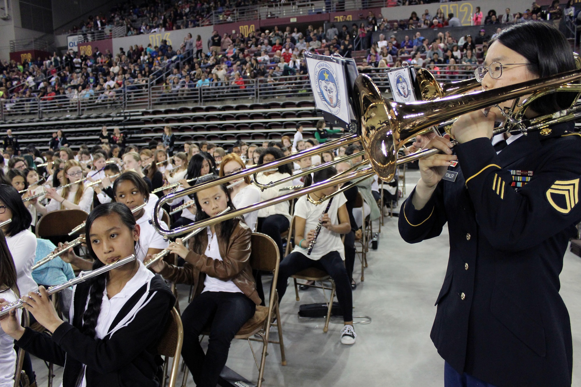 Staff Sgt. Nami Fowler with U.S. Army Alaska’s 9th Army Band performs alongside the flute section at Sonic Boom May 4 at the Sullivan Arena in Anchorage. More than 2,000 sixth-grade band and orchestra students performed at the event, showcasing the skills they’ve learned during their first year of music education with the Anchorage School District.