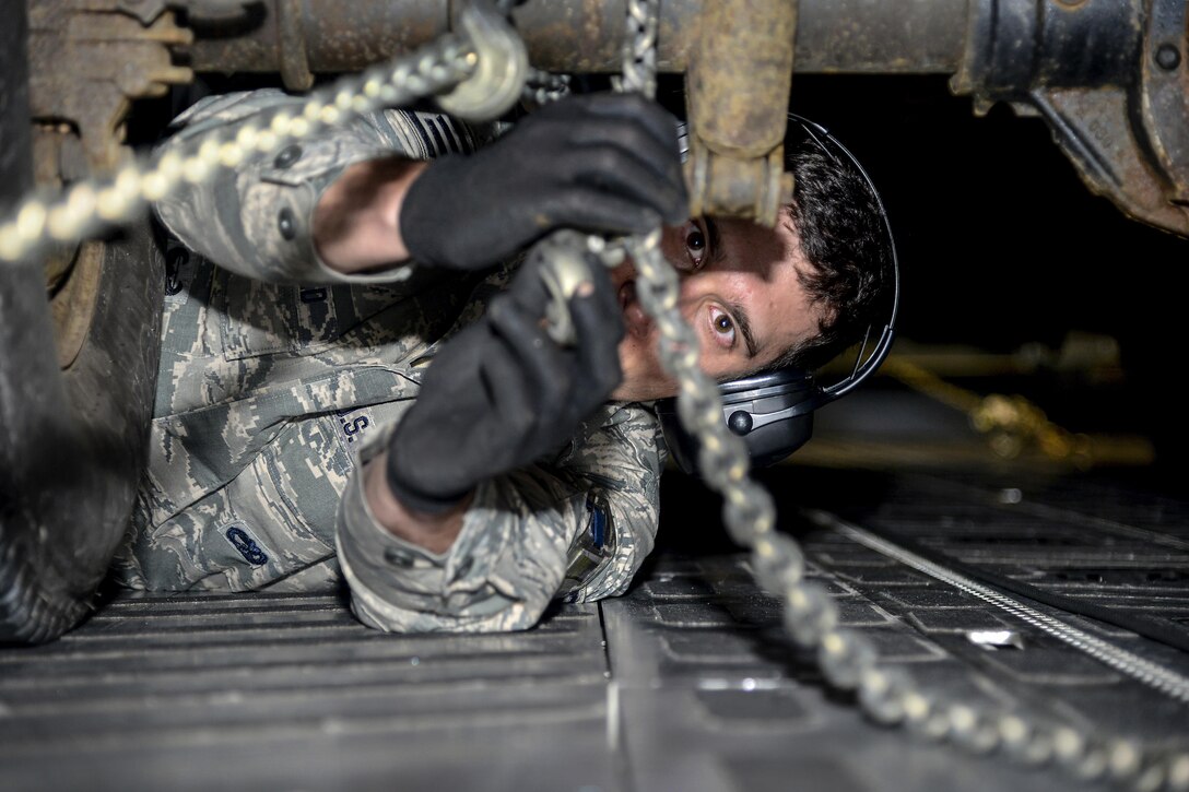 Air Force Staff Sgt. Nicholas Wingfield secures a pickup truck to a C-17 Globemaster III during an exercise at Stewart Air National Guard Base in Newburgh, N.Y., May 7, 2017. More than 100 airmen helped test the 105th Airlift Wing’s ability to deploy a large number of personnel and assets. Air Force photo by Staff Sgt. Julio A. Olivencia Jr..