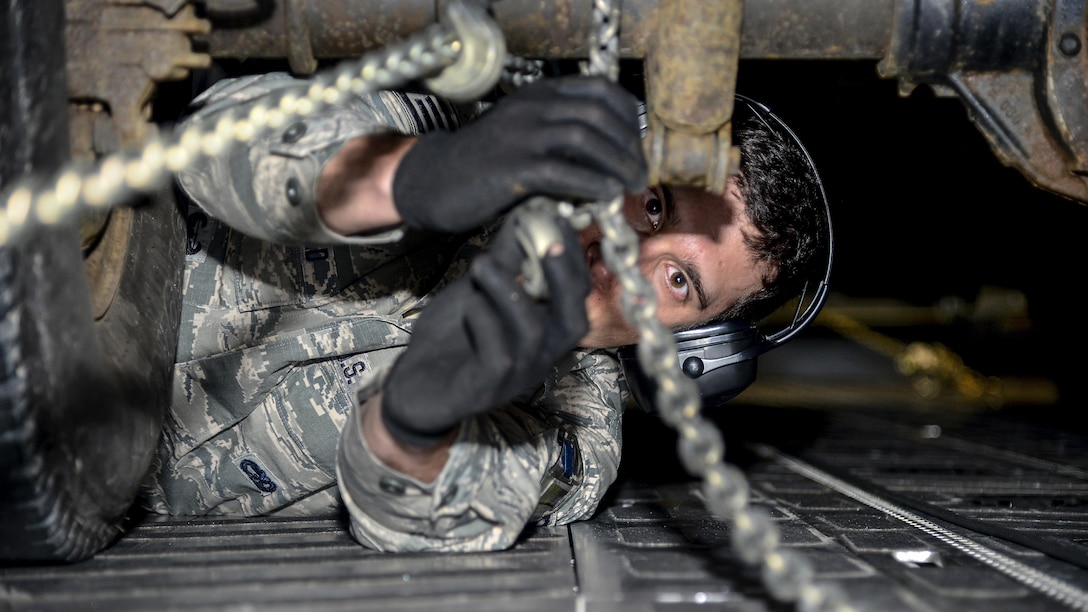 Air Force Staff Sgt. Nicholas Wingfield secures a pickup truck to a C-17 Globemaster III during an exercise at Stewart Air National Guard Base in Newburgh, N.Y., May 7, 2017. More than 100 airmen helped test the 105th Airlift Wing’s ability to deploy a large number of personnel and assets. Air Force photo by Staff Sgt. Julio A. Olivencia Jr.