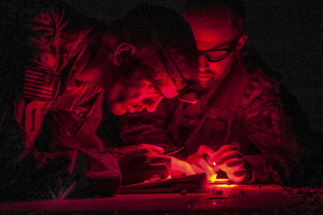 Members of the West Virginia National Guard check their location on a map before beginning a nighttime land navigation test during the 2017 Gainey Cup at Fort Benning, Ga., May 3, 2017. Army photo by Sgt. 1st Class Peter Morrison