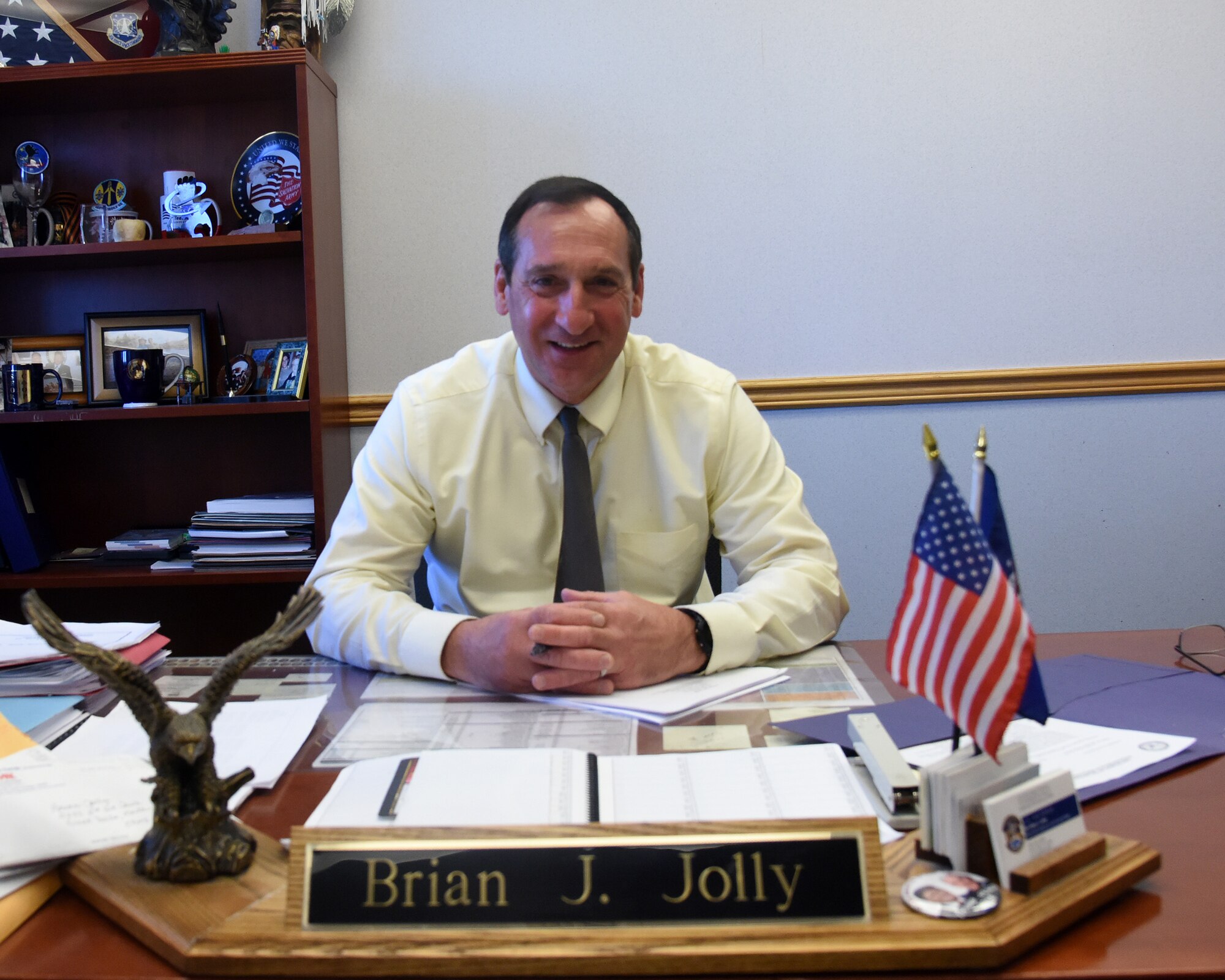 Brian Jolly, 341st Force Support Squadron manpower and personnel chief, poses at his desk May 8, 2017, at Malmstrom Air Force Base, Mont. Jolly retired from the Air Force as a chief after serving 29 years, and now uses those same leadership techniques to lead military and civilian personnel. (U.S. Air Force photo/Senior Airman Jaeda Tookes)