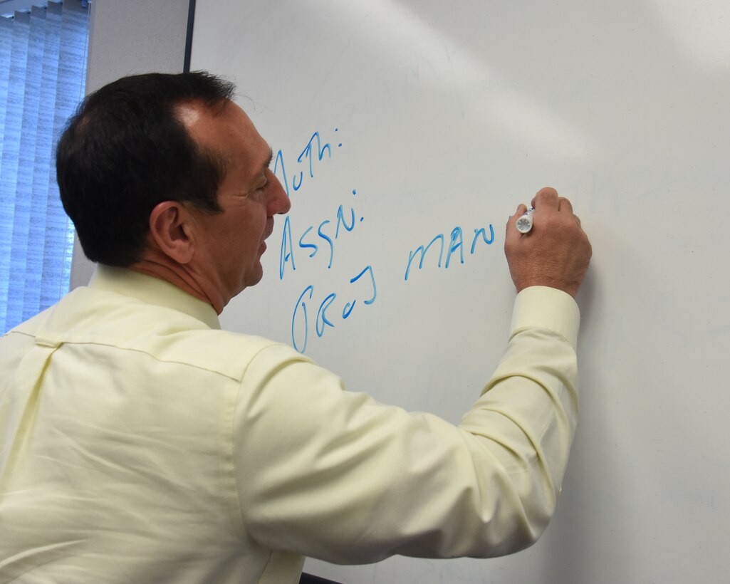 Brian Jolly, 341st Force Support Squadron manpower and personnel chief, writes down a projected assignment for a member May 8, 2017, at Malmstrom Air Force Base, Mont. Jolly keeps track of people permanently changing stations, rank changes and any other life events going on amongst his members. (U.S. Air Force photo/Senior Airman Jaeda Tookes)