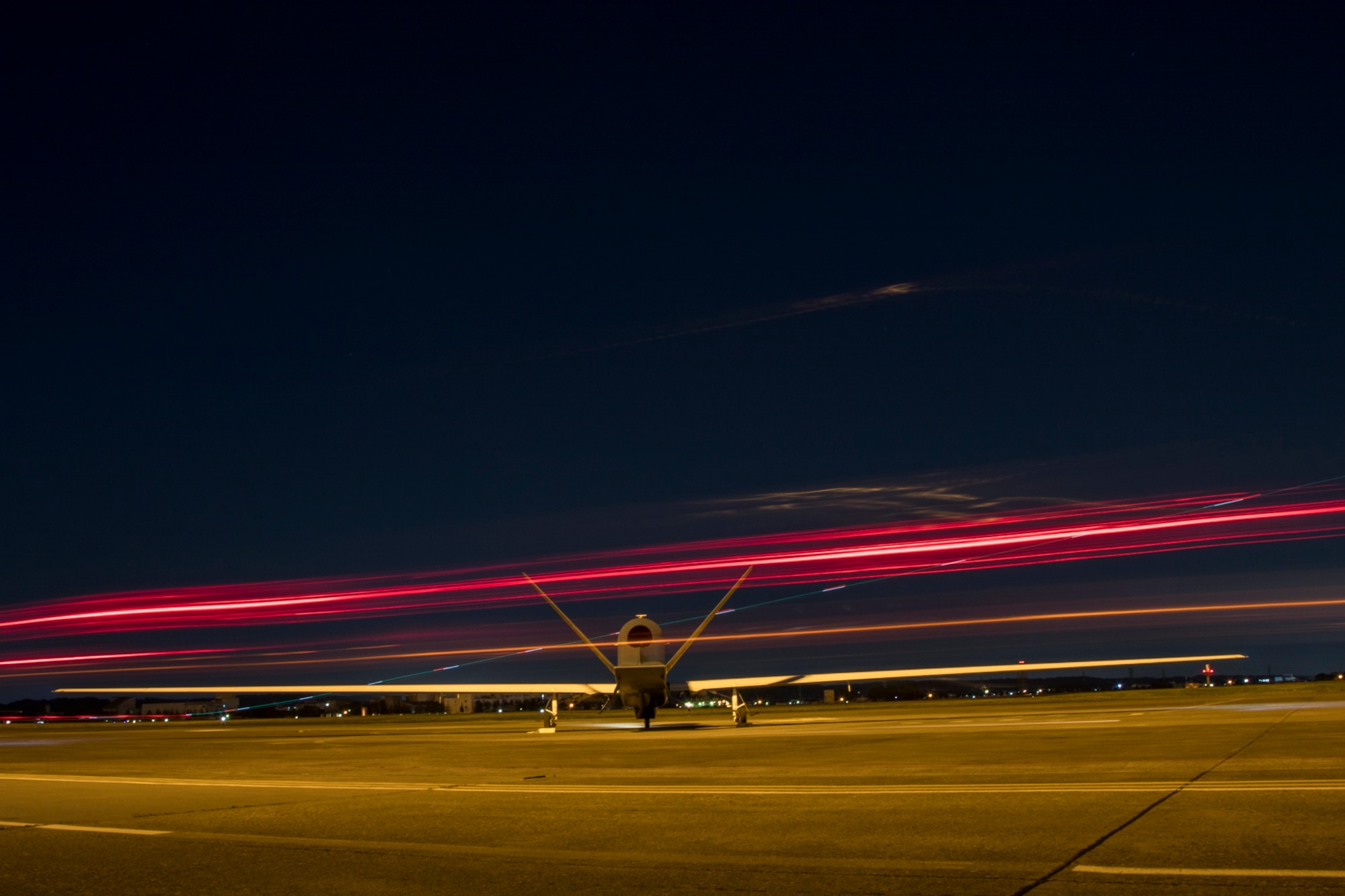 An RQ-4 Global Hawk’s engine warms up while planes take off and support vehicles pass by May 5, 2017, at Yokota Air Base, Japan. The Global Hawk is a high-altitude, long-endurance, remotely piloted and unarmed, aerial reconnaissance system. (U.S. Air Force photo by Airman 1st Class Donald Hudson)