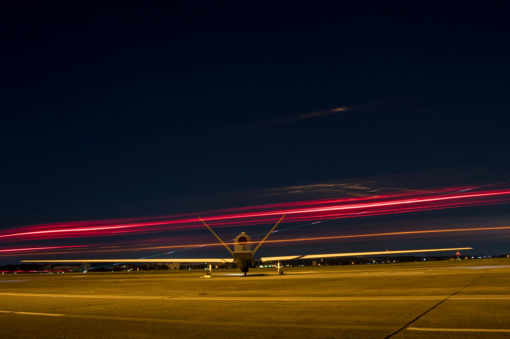 An RQ-4 Global Hawk’s engine warms up while planes take off and support vehicles pass by May 5, 2017, at Yokota Air Base, Japan. The Global Hawk is a high-altitude, long-endurance, remotely piloted and unarmed, aerial reconnaissance system. (U.S. Air Force photo by Airman 1st Class Donald Hudson)