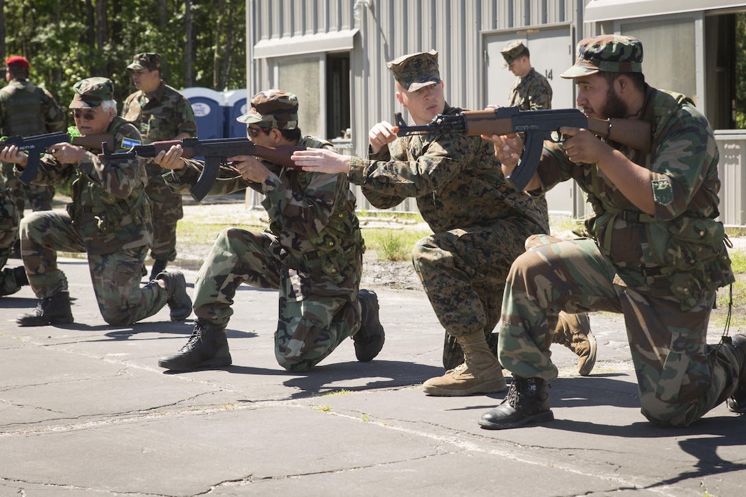 Sgt. Patrick J. Okeefe, second from right, teaches basic marksmanship to role players during General Exercise 2 at Marine Corps Base Camp Lejeune, North Carolina, May 4, 2017. The Marines conducted the final rehearsal exercise of the Marine Advisor Course in order to assess their readiness to train foreign security forces during their upcoming deployment to Central America. Okeefe is a tactics instructor with the Ground Combat Element, Special Purpose Marine Air-Ground Task Force - Southern Command. The Marine Advisor Course is taught by the Marine Corps Security Cooperation Group. Marine Corps photo by Sgt. Ian Leones
