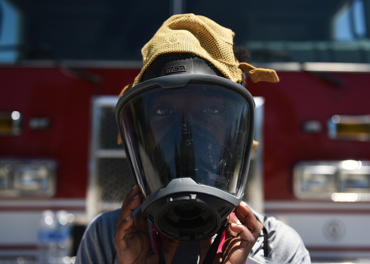 Sidney Dew, a Tyndall Jr. Raptor participant, tries on a protective mask used by firefighters at the Tyndall Air Force Base, Fla., Silver Flag site May 6, 2017. Dew was one of 63 children who had the opportunity to experience what it is like to walk in a military member’s boots as part of the annual Jr. Raptor program. (U.S. Air Force photo by Senior Airman Sergio A. Gamboa/Released)