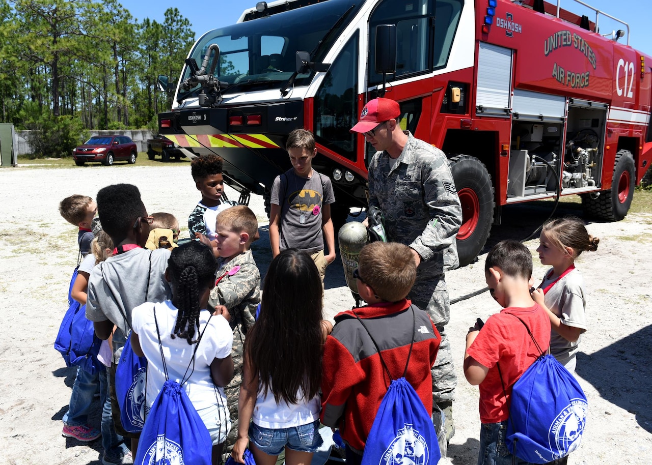 Children participating in the Tyndall Jr. Raptor program hosted by the 325th Force Support Squadron Youth Center receive a briefing on firefighter equipment at the Tyndall Air Force Base, Fla., Silver Flag site May 6, 2017. Members from the Det. 1, 823rd REDHORSE Squadron gave the 63 Jr. Raptors in attendance a tour of the different equipment they use, including different military vehicles. (U.S. Air Force photo by Senior Airman Sergio A. Gamboa/Released)