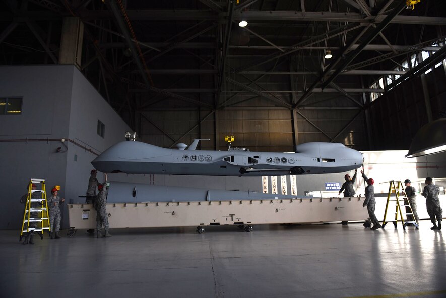 432nd Aircraft Maintenance Squadron maintainers unpack the MQ-9 Reaper model May 5, 2017, at Travis Air Force Base, Calif. The aircraft was displayed at the Wings Over Solano air show for spectators to see an actual MQ-9 and learn about the Reaper's capabilities. (U.S. Air Force photo/Senior Airman Christian Clausen