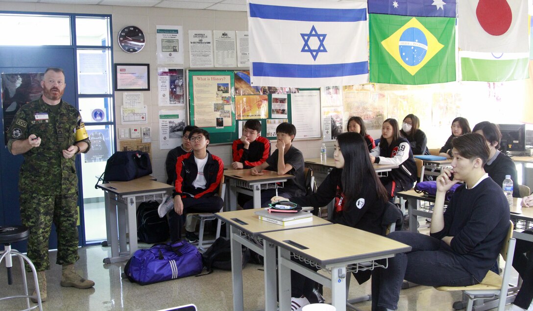 Commander Robert J. Watt, chief of staff of United Nations Command Military Armistice Commission talks with students attending Model United Nations activity at Yongsan International School of Seoul, April 21.