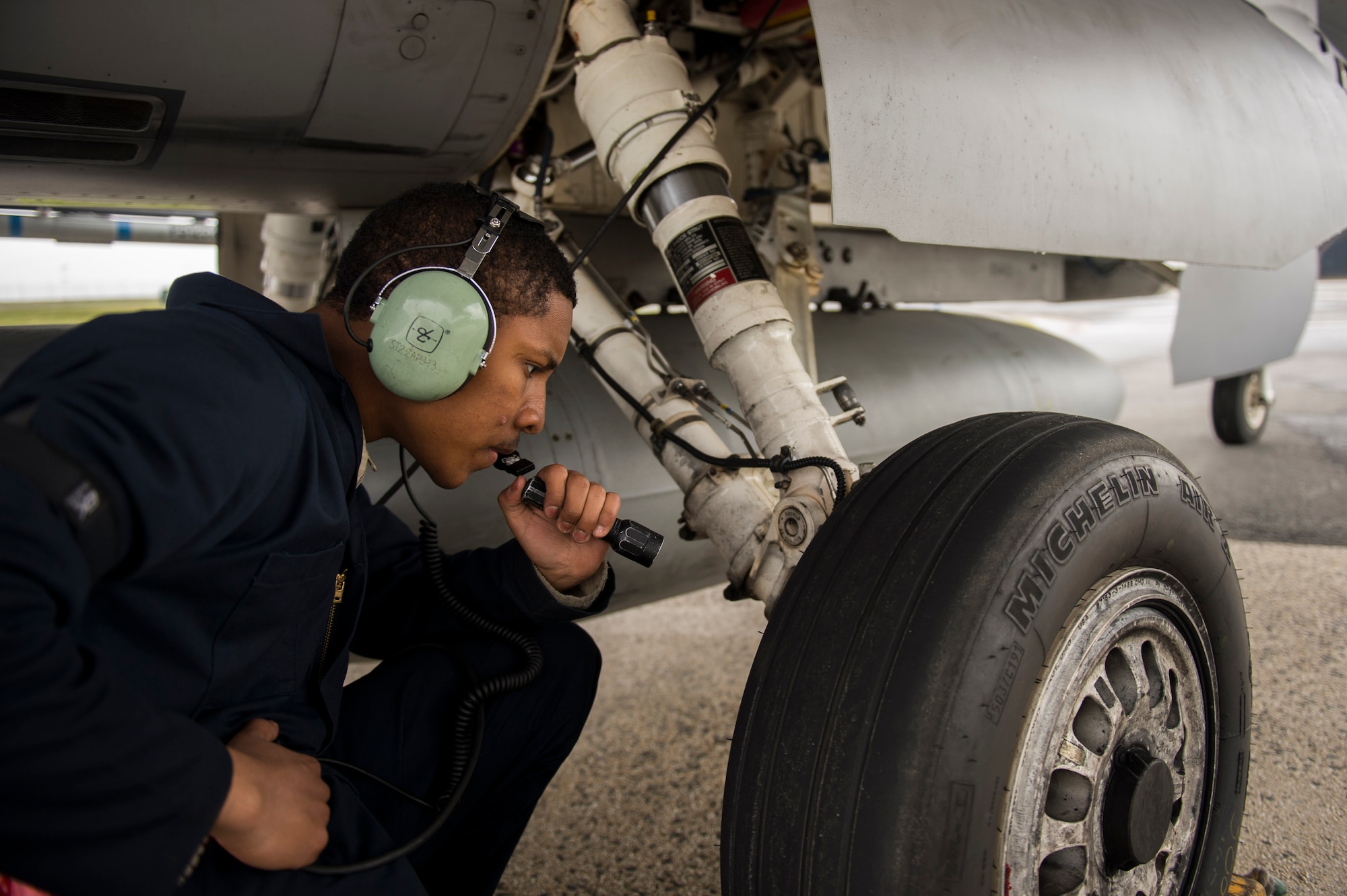 Airman 1st Class Derek Larsen, 52nd Aircraft Maintenance Squadron assistant dedicated crew chief, inspects the tire of a U.S. Air Force F-16 Fighting Falcon assigned to the 480th Fighter Squadron during a "14 front" launch at Spangdahlem Air Base, Germany, May 4th, 2017. From April 24 to May 5, the 480th FS and 52nd Aircraft Maintenance Squadron supported 26 sorties a day, 14 in the morning and 12 in the afternoon. This flying tempo is referred to as a, “14 turn 12,” and is a 16 percent increase over normal operations. During normal operations, it’s standard to launch a 12 turn 10, or 4 fewer sorties per day. Preparing and launching 14 aircraft in one go is referred to as a “14 front.” (U.S. Air Force photo by Preston Cherry)