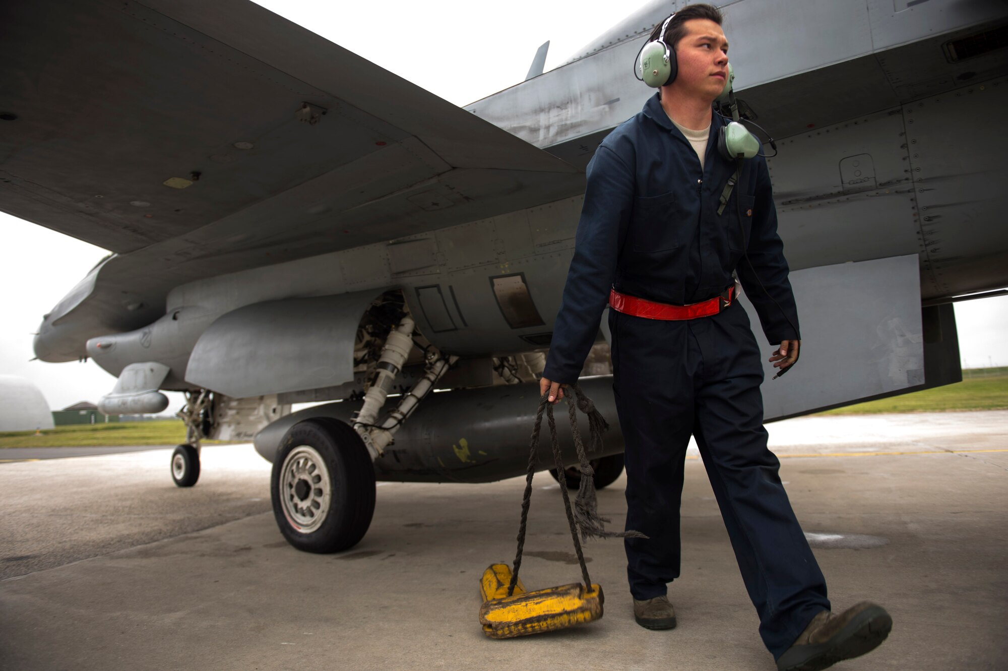 Airman 1st Class Darren Arellano, 52nd Aircraft Maintenance Squadron assistant dedicated crew chief, pulls wheel chocks from under a U.S. Air Force F-16 Fighting Falcon assigned to the 480th Fighter Squadron during a "14 front" launch at Spangdahlem Air Base, Germany, May 4th, 2017. From April 24 to May 5, the 480th FS and 52nd Aircraft Maintenance Squadron supported 26 sorties a day, 14 in the morning and 12 in the afternoon. This flying tempo is referred to as a, “14 turn 12,” and is a 16 percent increase over normal operations. During normal operations, it’s standard to launch a 12 turn 10, or 4 fewer sorties per day. Preparing and launching 14 aircraft in one go is referred to as a “14 front.” (U.S. Air Force photo by Preston Cherry)