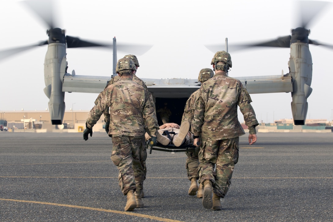 U.S. Army combat medics, with the 86th Combat Support Hospital, move a simulated casualty onto a MV-22 Osprey, during a joint training exercise with Marines from Marine Medium Tiltrotor Squadron - 364 (VMM-364), at Camp Arifjan, Kuwait, May 8, 2017. (U.S. Army Photo by Sgt. Christopher Bigelow)