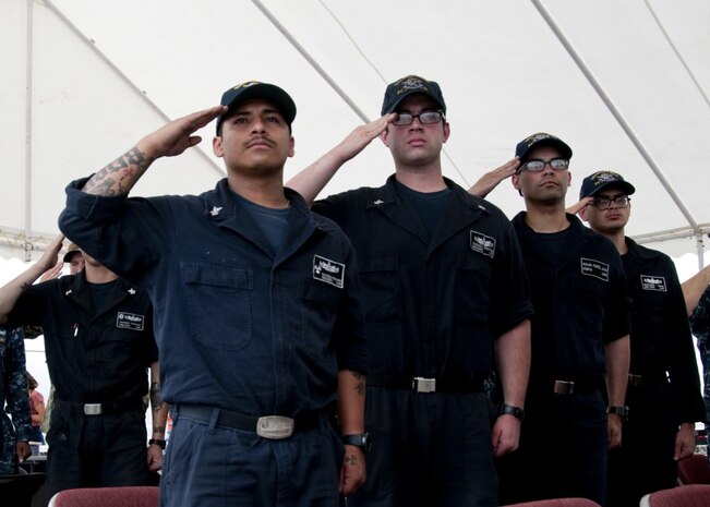 Sailors assigned to the Cyclone-class coastal patrol ship (PC) USS Whirlwind (PC 11) salute the ensign during the national anthem during the ship's change of command ceremony at Naval Support Activity Bahrain. The primary mission of the PCs is maritime security operations, and Whirlwind is one of 10 PCs forward deployed to Manama, Bahrain. 