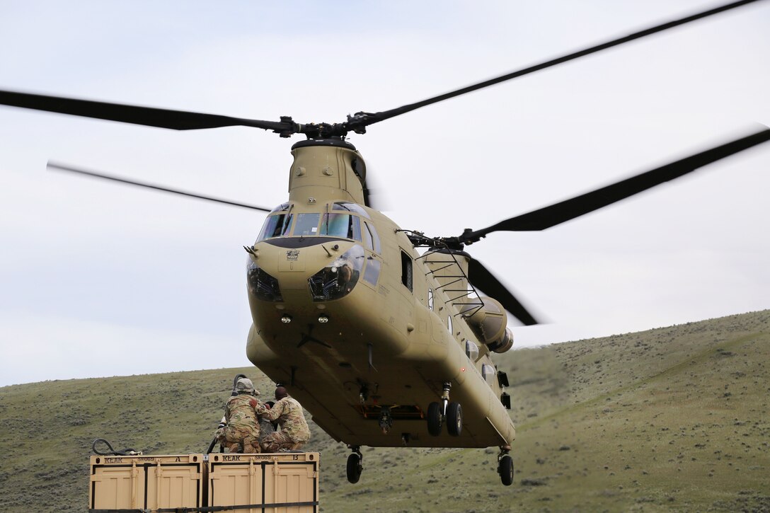 Soldiers prepare to attach a container to a CH-47 Chinook helicopter during a slingload operation, part of Exercise Dragon Fire, at the Yakima Training Center, Yakima, Wash., May 5, 2017. Army photo by Sgt. Kalie Jones