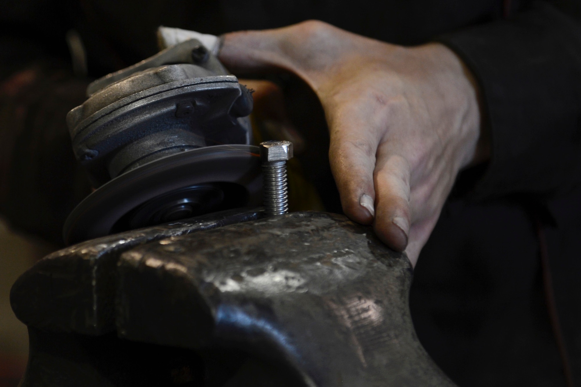 U.S. Army Spc. Anthony Cole, 558th Transportation Company, 10th Battalion, 7th Transportation Brigade (Expeditionary) allied trade specialist, grinds a bolt head away at Joint Base Langley-Eustis, Va., May 4, 2017. Welding requires precision handling and attention to detail, however it also allows room for a touch of artistic flare. (U.S. Air Force photo/Airman 1st Class Kaylee Dubois)
