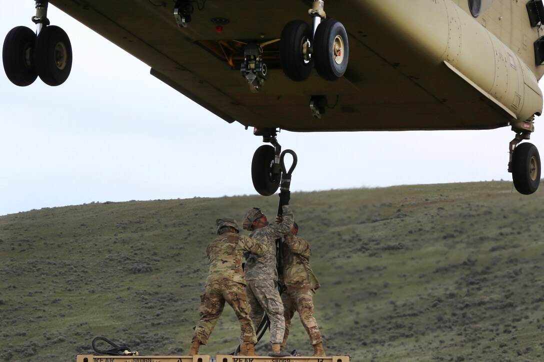 Soldiers attach a container to a CH-47 Chinook helicopter during a slingload operation, part of Exercise Dragon Fire, at the Yakima Training Center, Yakima, Wash., May 5, 2017. Army photo by Sgt. Kalie Jones