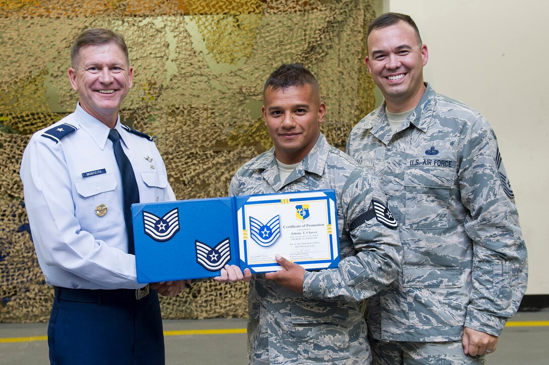 Brig. Gen. Wayne Monteith, 45th Space Wing commander, and Chief Master Sgt. Alexander Hall, 45th Space Wing interim command chief, (right), promote Staff. Sgt. Johnny Chavez, 45th Civil Engineer Squadron electrical systems craftsman, to the rank of technical sergeant as part of the Stripes for Exceptional Performers program, or STEP, May 9, 2017, at Patrick Air Force Base, Fla. The STEP program allows Air Force leaders to select Airmen with outstanding potential for promotion to the grades of staff sergeant through master sergeant, which occurs outside of a traditional promotion cycle. (U.S. Air Force photo by Phil Sunkel) 