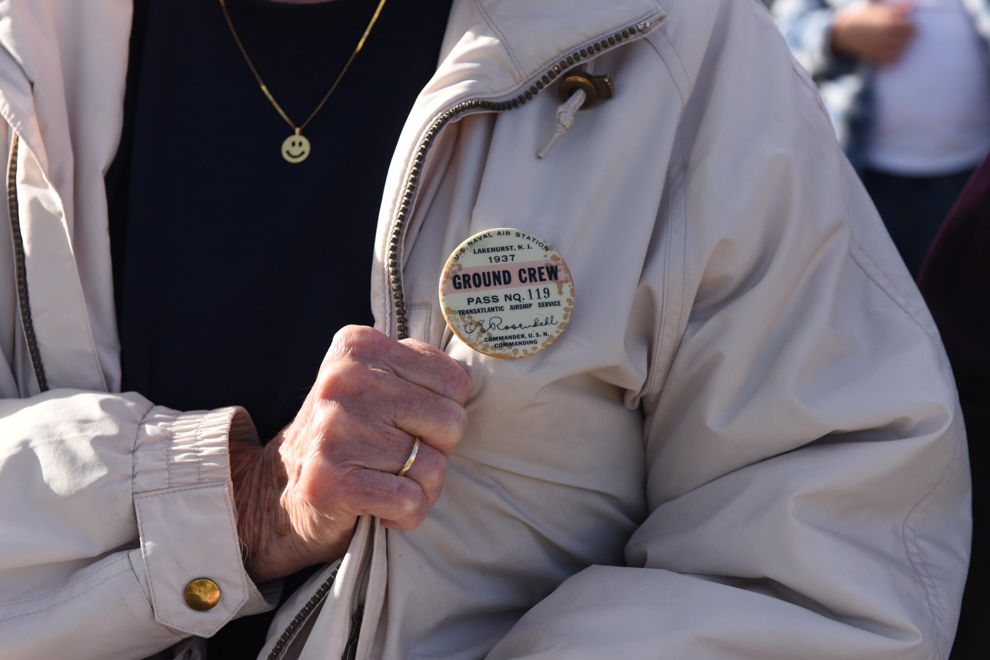 Ann Camp, the daughter of a ground crewmember present at the time of the Hindenburg disaster displays her father's ground crew member badge at the 80th anniversary of the disaster at Joint Base McGuire-Dix-Lakehurst, New Jersey, May 6, 2017. Camp's father, Bill Farrington, was forced to run from the crash site as the Hindenburg went up in flames.