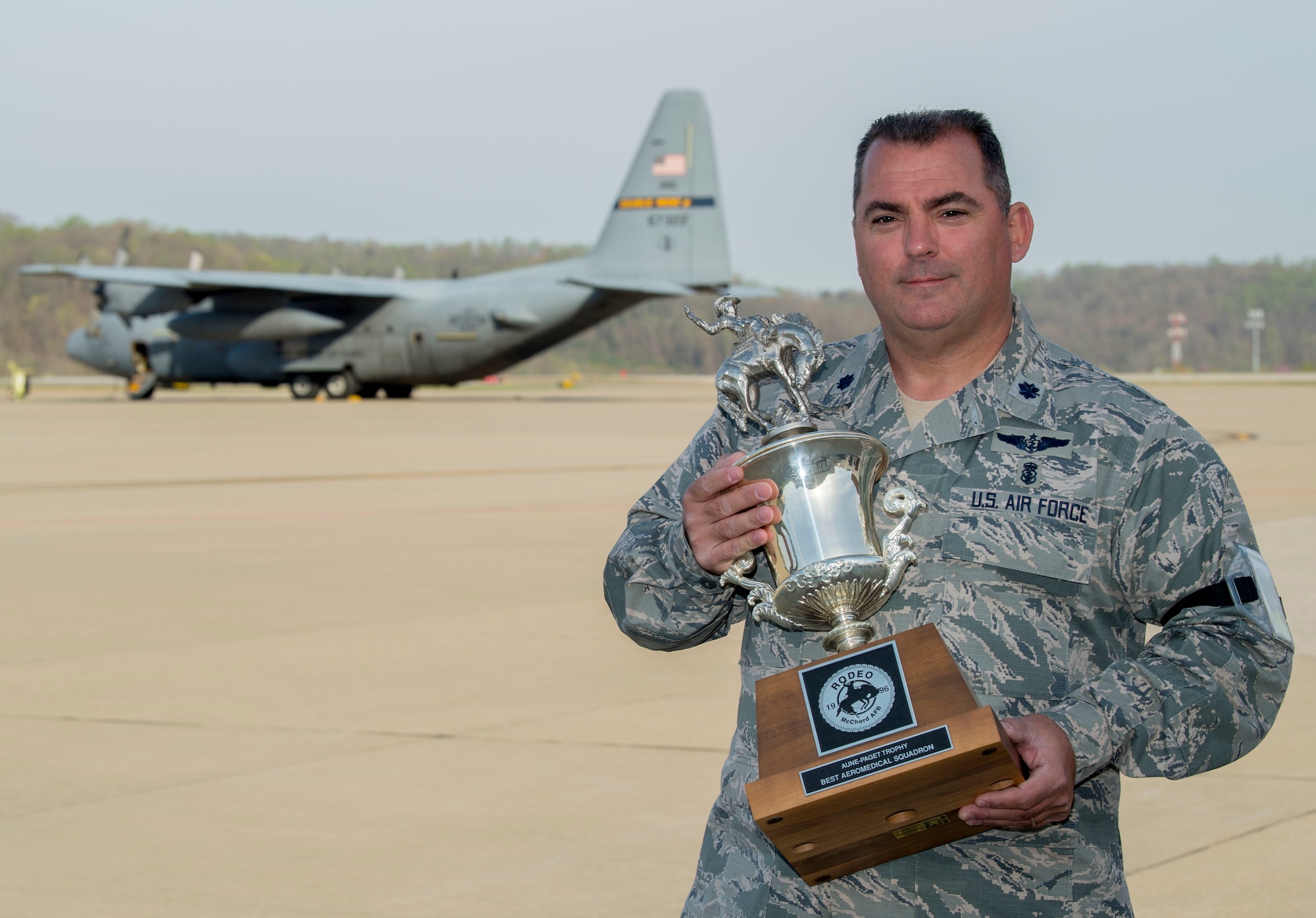 Lt. Col. Joseph Buonocore holds the Aune-Paget trophy from the 1996 Air Mobility Command Rodeo. Bonocore was a member of the five-man rodeo team from the 167th Aeromedical Evacuation Squadron that won the inaugural Best Aeromedical Evacuation Squadron award. Bunoncore is a 35-year veteran of the West Virginia Air National Guard who was a part of the 167th AES at both the 167th Airlift Wing and 130th Airlift Wing. (U.S. Air National Guard photo by Tech. Sgt. De-Juan Haley)
