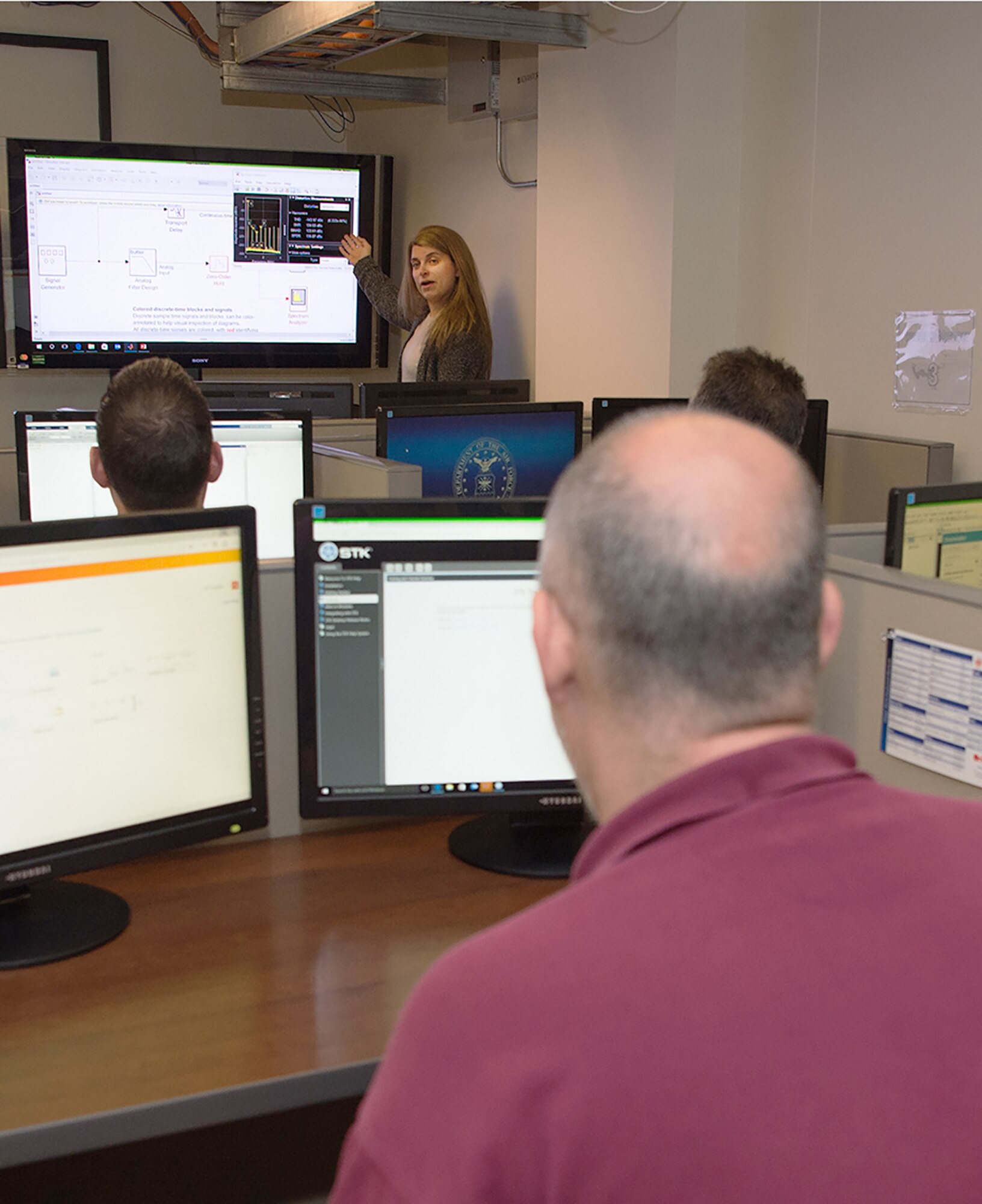 Dr. Bahareh Haji-saeed, an Air Force Life Cycle Management Center chief engineer, demonstrates an advanced engineering computer program in the Hanscom Engineering and Analysis Training lab on May 1, its opening day. The HEAT lab is in the Hanscom Collaboration and Innovation Center and allows authorized base personnel to operate advanced computer programs on powerful networked machines. The HEAT lab is open for reservation through SharePoint. Machines in the lab are connected to the Defense Research and Engineering Network and software available for use includes various computer-aided design programs, analytics tools and software development bundles.  (U.S. Air Force photo by Jerry Saslav)
