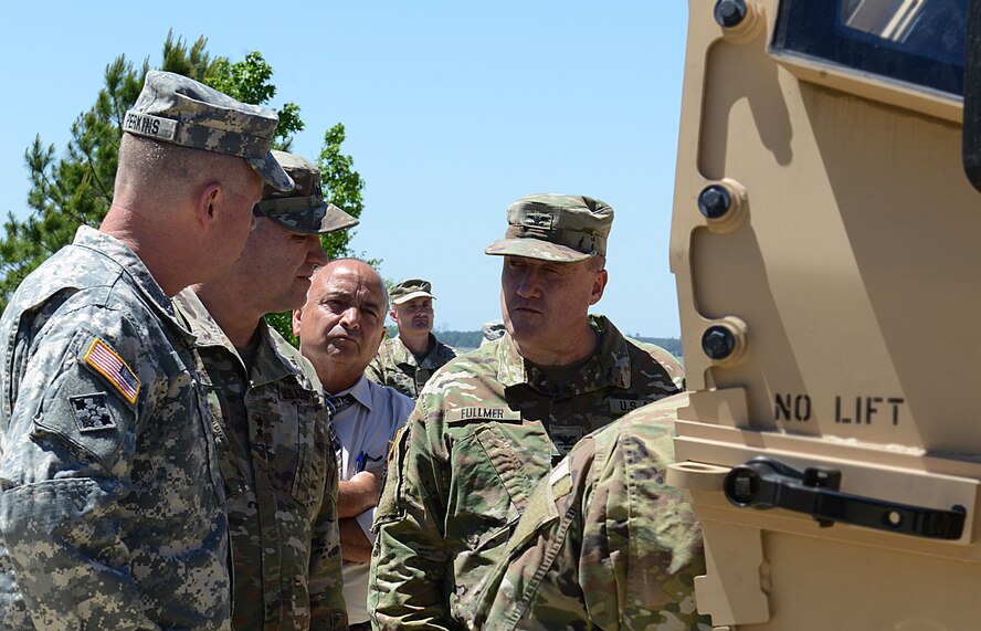U.S. Army Gen. David Perkins, commanding general, U.S. Army Training and Doctrine Command, and Maj. Gen. Bo Dyess, Army Capabilities Integration Center director, are briefed by Col. Shane Fullmer, JLTV joint project manager on a production model Joint Light Tactical Vehicle at Joint Base Langley-Eustis, Va., May 2, 2017. The JLTV program is an Army-led agenda collaborating with the U.S. Marine Corps to replace a portion of each branch's light tactical vehicle fleets.  (U.S. Air Force photo/Staff Sgt. Teresa J. Cleveland)