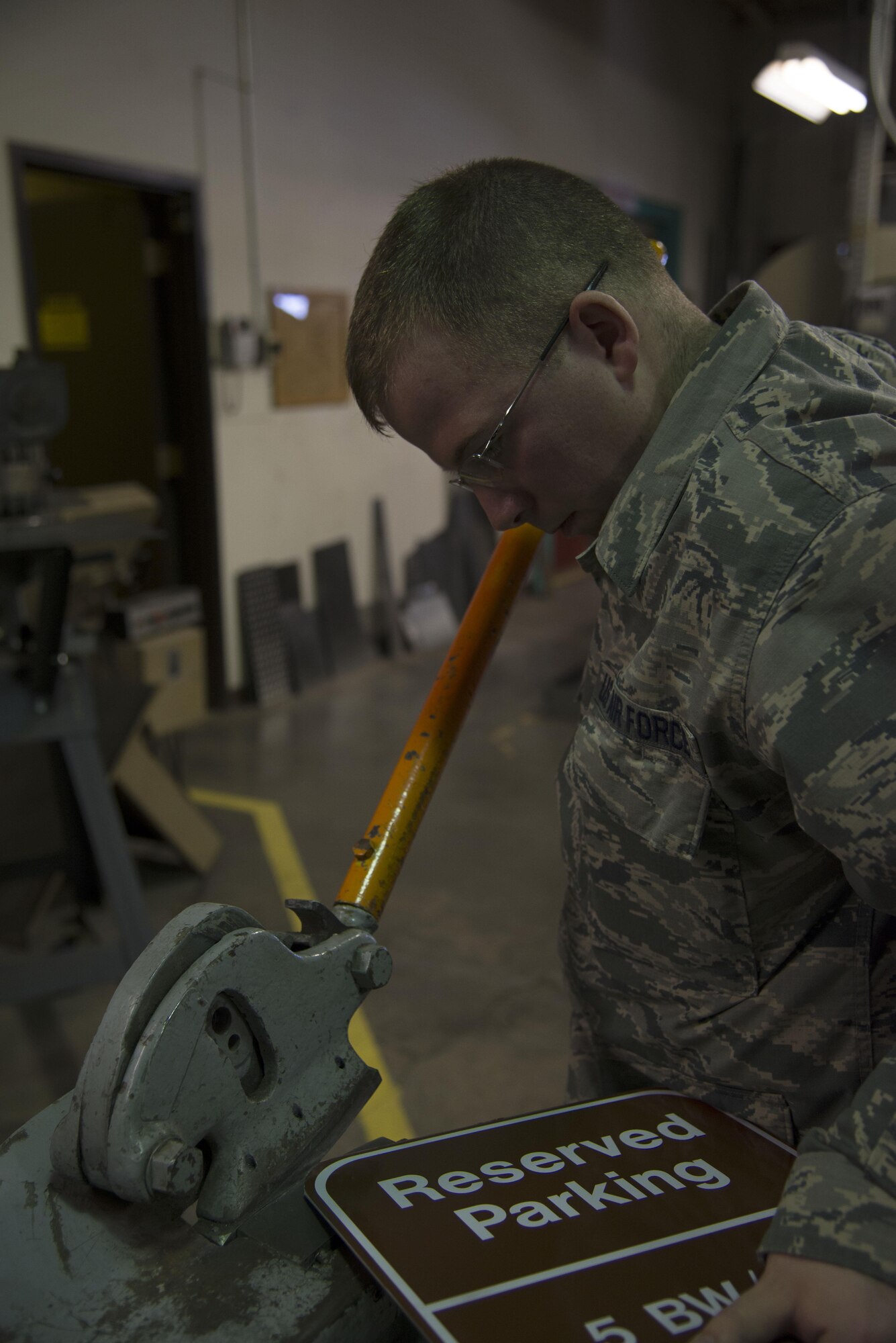 Staff Sgt. Horace Hand, 5th Civil Engineer Squadron structural craftsman, shapes a sign at the sign shop on Minot Air Force Base, N.D., April 27, 2017. The sign shop produces about 20-25 signs per week. (U.S. Air Force photo/Airman 1st Class Dillon Audit)