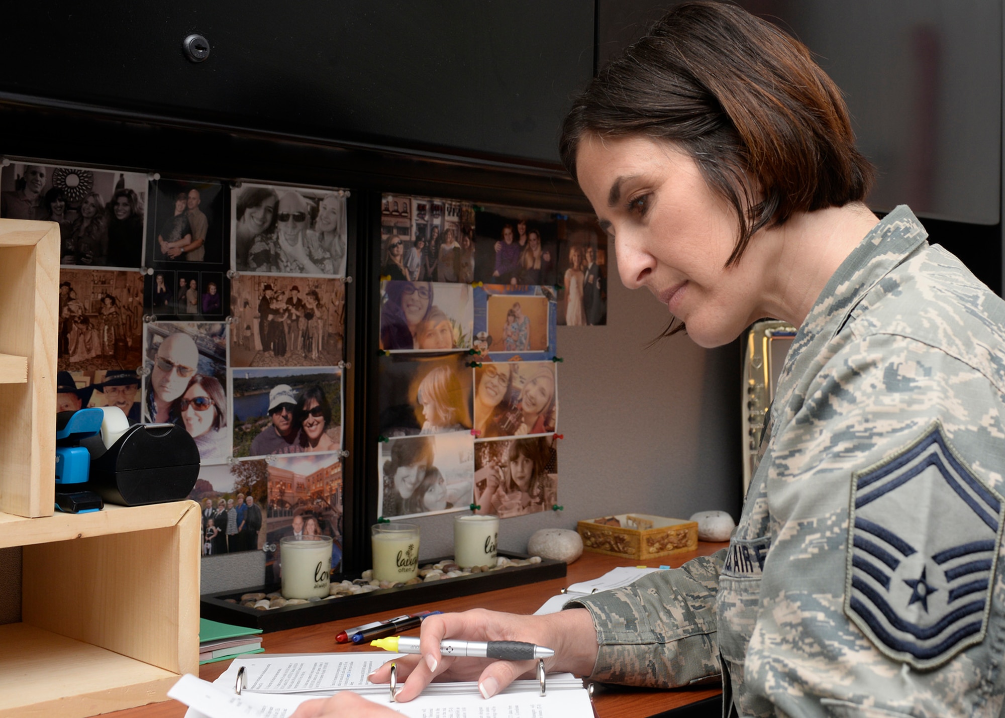 Senior Master Sgt. Laurice Souron, the inspector general from the 157th Air Refueling Wing, works in her office filled with photos of her children at Pease Air National Guard Base, N.H. April 27, 2017. (U.S. Air National Guard photo by Airman Victoria Nelson)