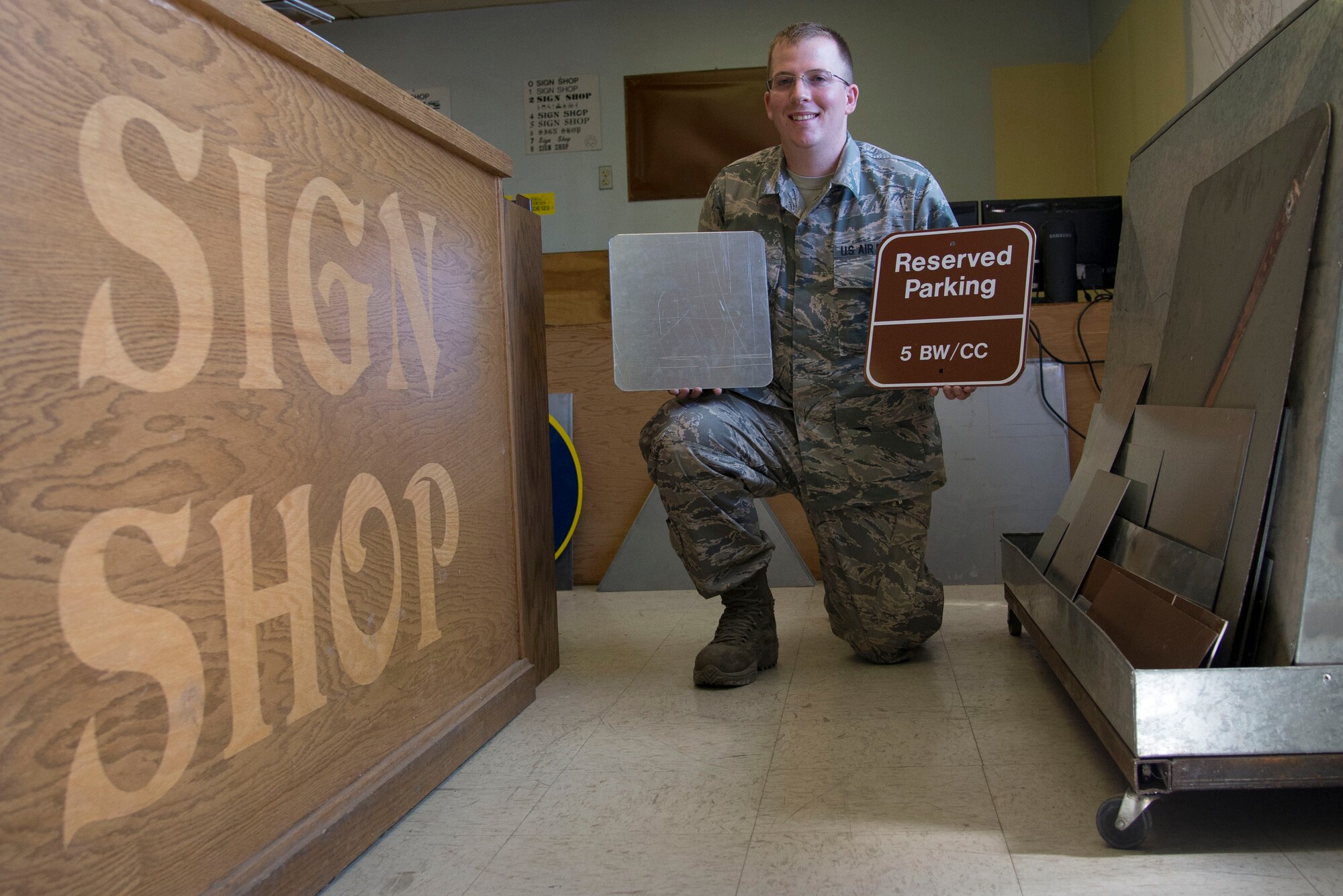 Staff Sgt. Horace Hand, 5th Civil Engineer Squadron structural craftsman, presents a completed sign at Minot Air Force Base, N.D., April 27, 2017. The sign shop maintains all government signs on base and within the missle complex. (U.S. Air Force photo/Airman 1st Class Dillon Audit)