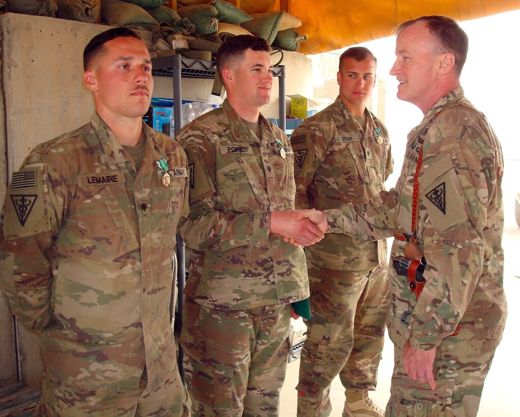 Col. Robert Suter, commander, 3rd Medical Command (Deployment Support) Forward, presents awards to Soldiers of the Forward Surgical Team at Forward Operating Base Dwyer, Helmand Province, Afghanistan, March 22, 2017. Sutter was conducting battlefield circulation to recognize U.S. Army Central Soldiers performance.