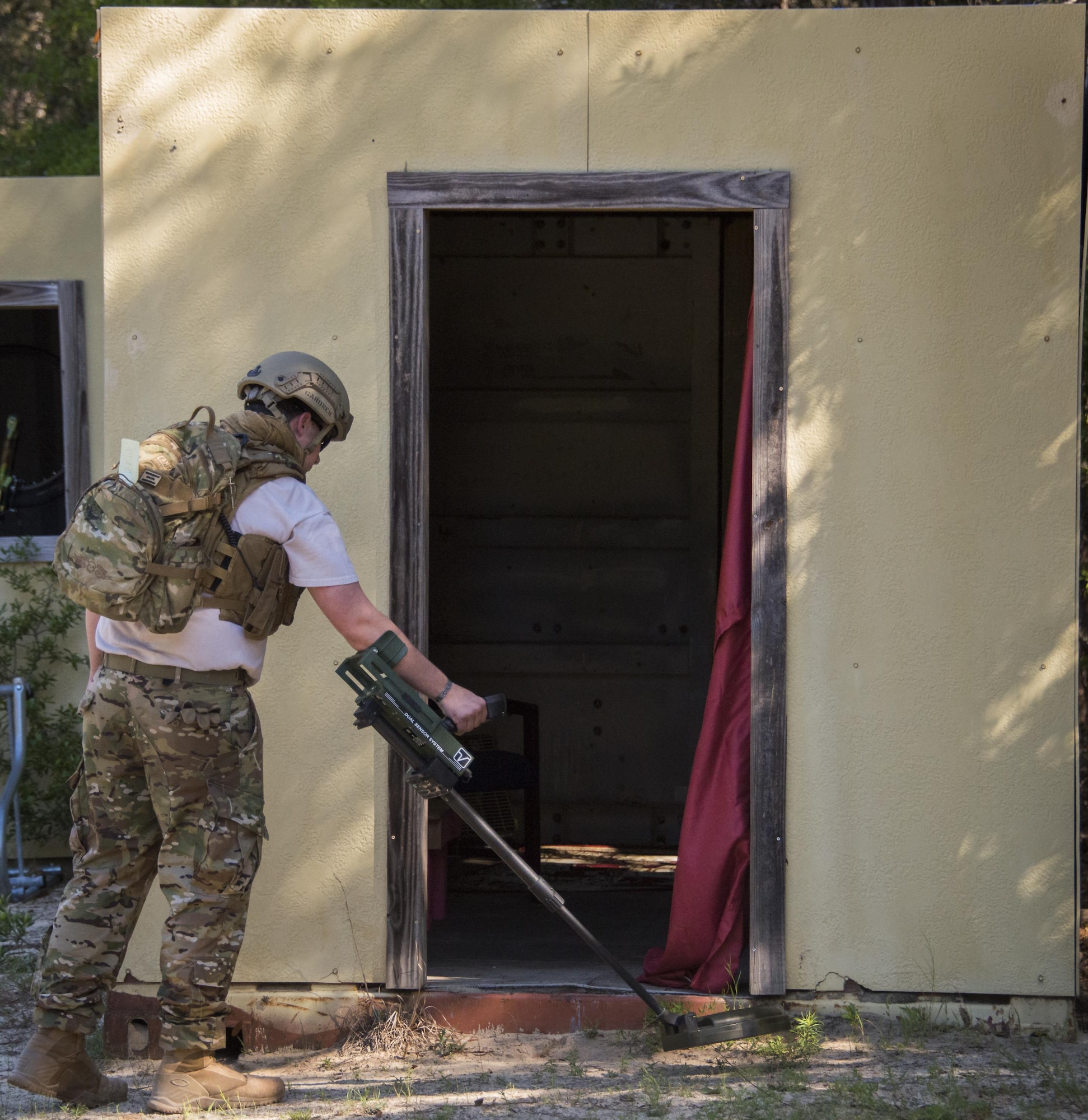 Staff Sgt. Justin Gardner, 788th Civil Engineer Squadron, Explosive Ordnance Disposal Flight, Wright Patterson Air Force Base, Ohio, sweeps the front of a building for improvised explosive devices during the EOD Warfighter Challenge at Eglin AFB, Fla. The challenge was a four-day, scenario-based, skills exchange between 17 EOD teams from across the Air Force. (U.S. Air Force photo/Cheryl Sawyers)