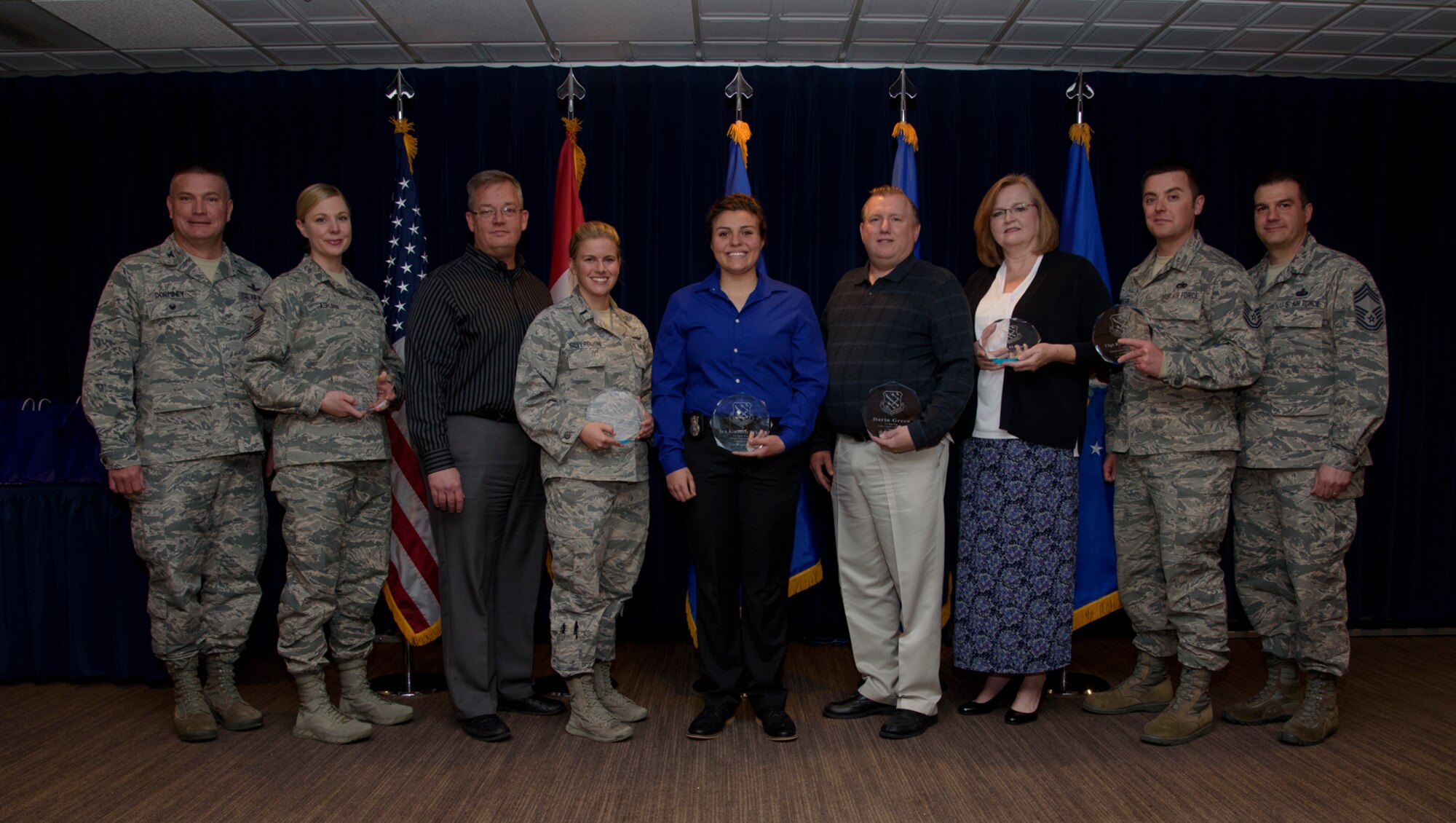 PETERSON AIR FORCE BASE, Colo. – 21st Space Wing Quarterly Award winners stand alongside leadership in the Club after winning their award at Peterson Air Force Base, Colo., April 27, 2017. Airmen from each 21st SW group competed against each other to win the wing-level award for the first quarter of 2017. (U.S. Air Force photo by Airman 1st Class Dennis Hoffman)