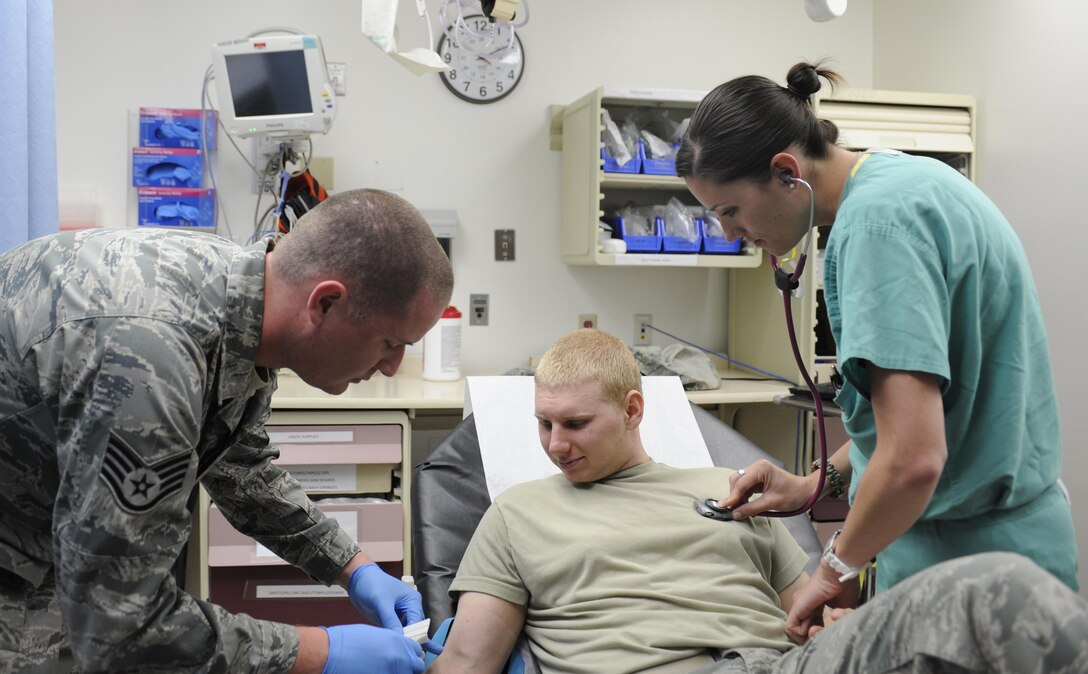 U.S. Air Force Staff Sgt. Andrew Day, 366th Medical Operations Squadron aerospace medicine technician and 1st Lt. Stephanie Doane, 366th MDOS clinical nurse, care for a patient at Mountain Home Air Force Base, Idaho. Primary care physicians, nurses and medical technicians make up the core team under Air Force Medical Home care model, and are joined by specialty care providers when needed.