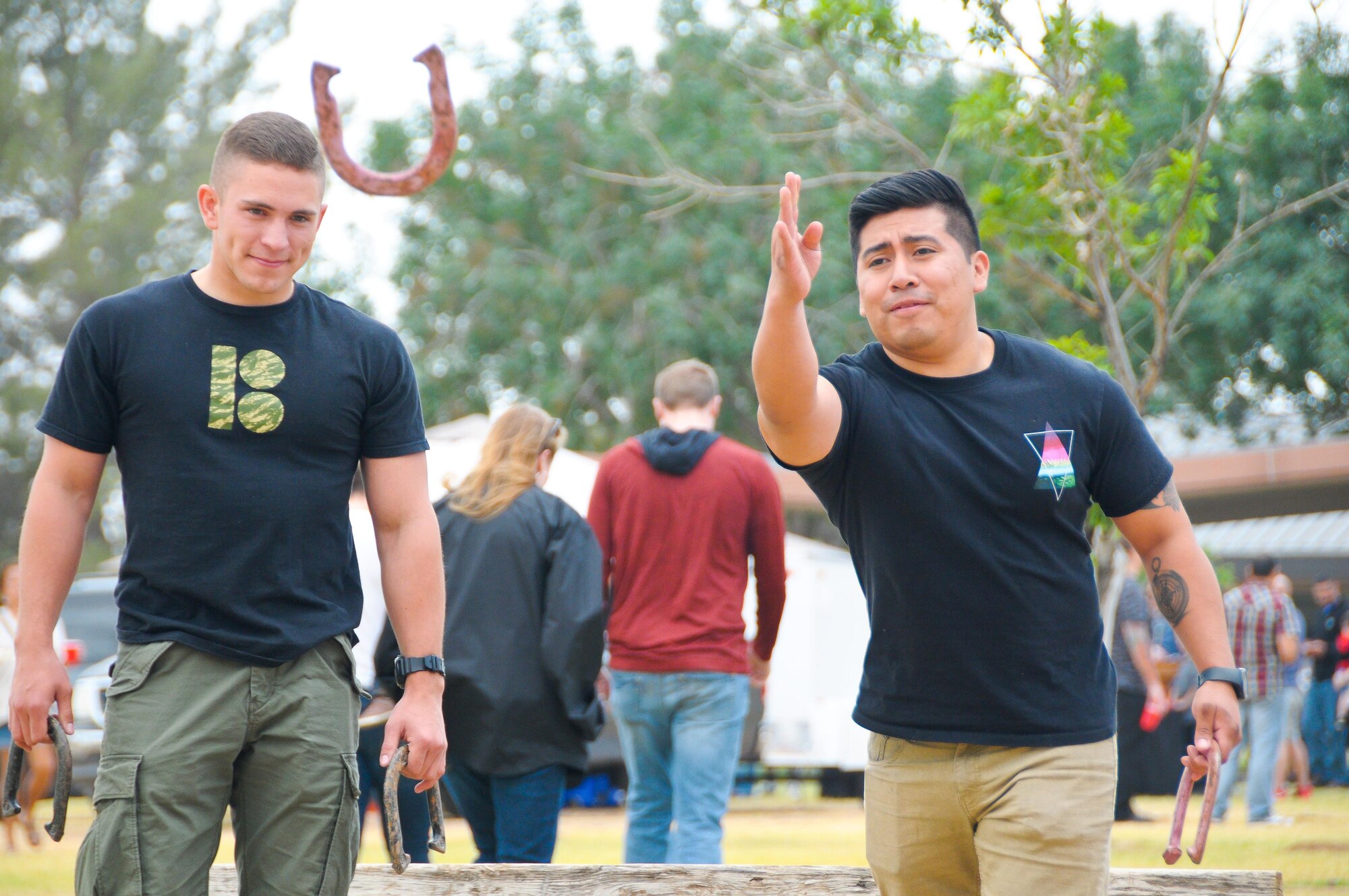 Airman Gabriel Coronado and Senior Airman Luis Pizarro, both 944th Fighter Wing Detachment 1 munitions systems apprentices, play a game of horseshoes during their unit’s Family Day picnic May 7 at Luke Air Force Base, Ariz. Representatives from various agencies including Benevilla Family Resource Center, Exceptional Family Member Program and Military One Source were on-hand to provide helpful information for Citizen Airmen and their families. (U.S. Air Force photo by Tech. Sgt. Nestor Cruz)