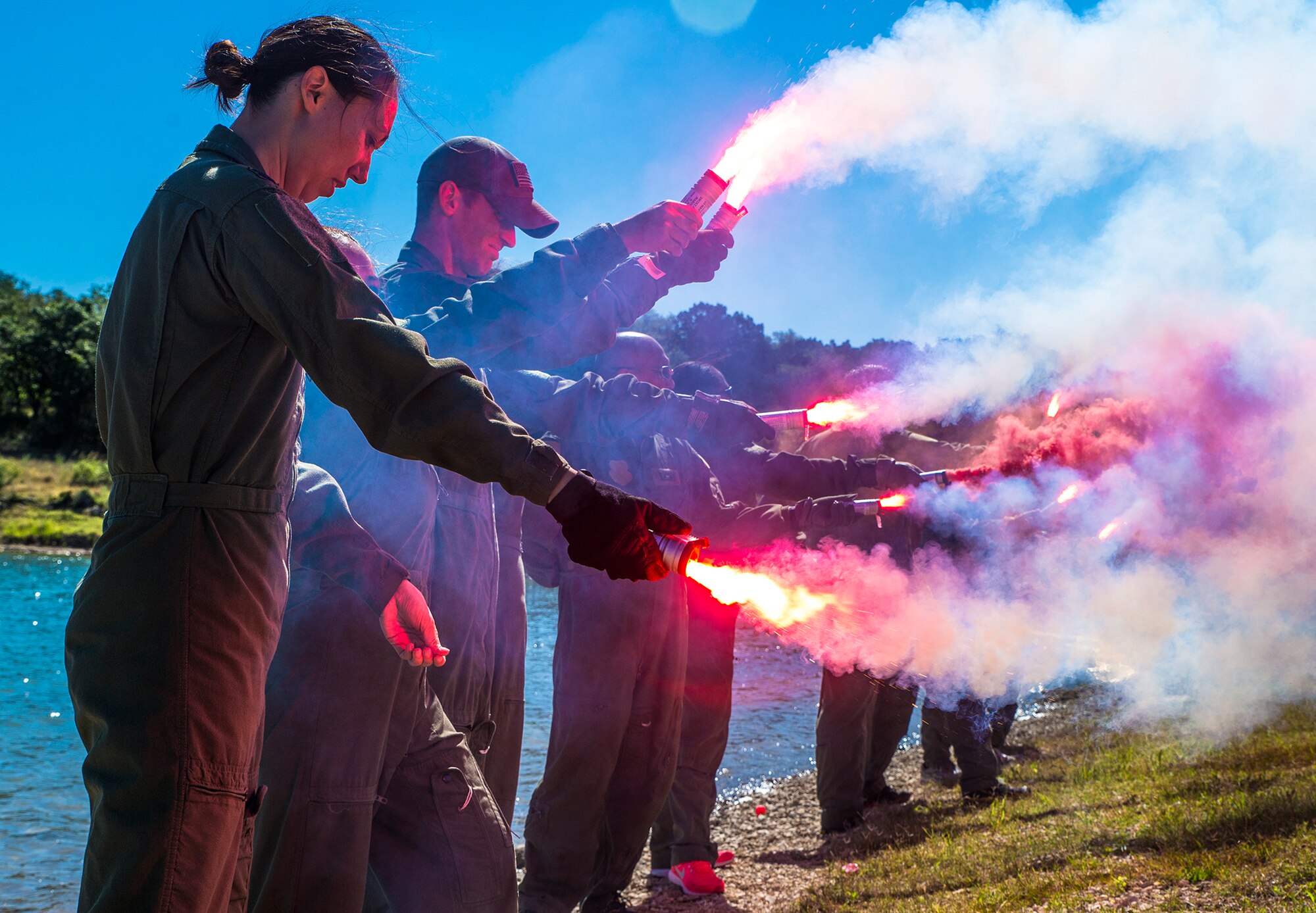 Capt. Charlie South, 433rd Aeromedical Evacuation Squadron flight nurse, deploys an MK-124 flare during water survival training May 5, 2017 at Joint Base San Antonio-Canyon Lake. The triannual training is a requirement for all aircrew Air Force Specialty Codes and includes open water swimming and life raft training. (U.S. Air Force photo by Benjamin Faske)