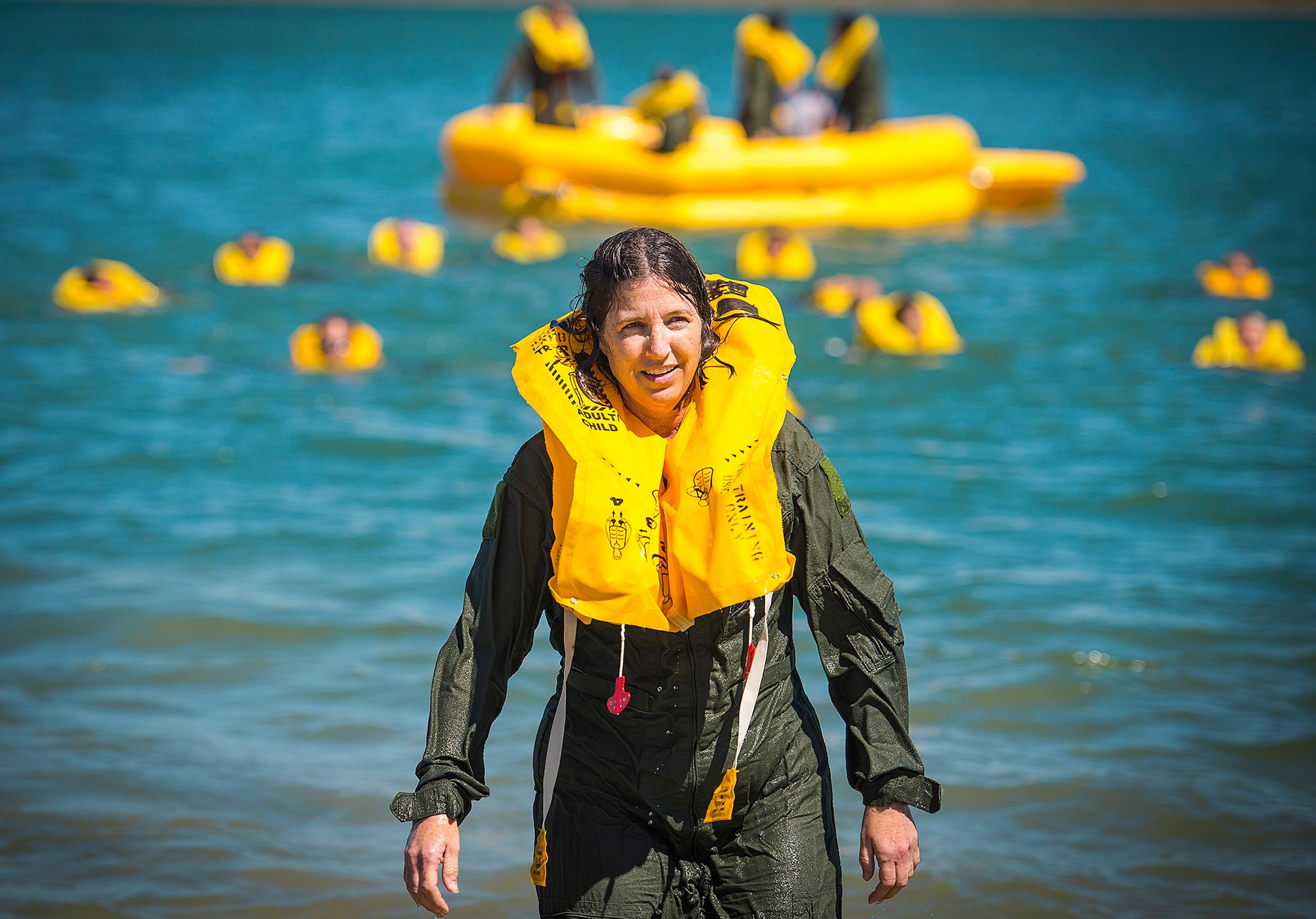 Lt. Col. Debbie Deja, 433rd Aeromedical Evacuation Squadron director of operations, emerges from the water after finishing life raft training May 5, 2017 at Joint Base San Antonio-Canyon Lake. The triannual training is a requirement for all aircrew Air Force Specialty Codes and includes open water swimming and life raft training. (U.S. Air Force photo by Benjamin Faske)