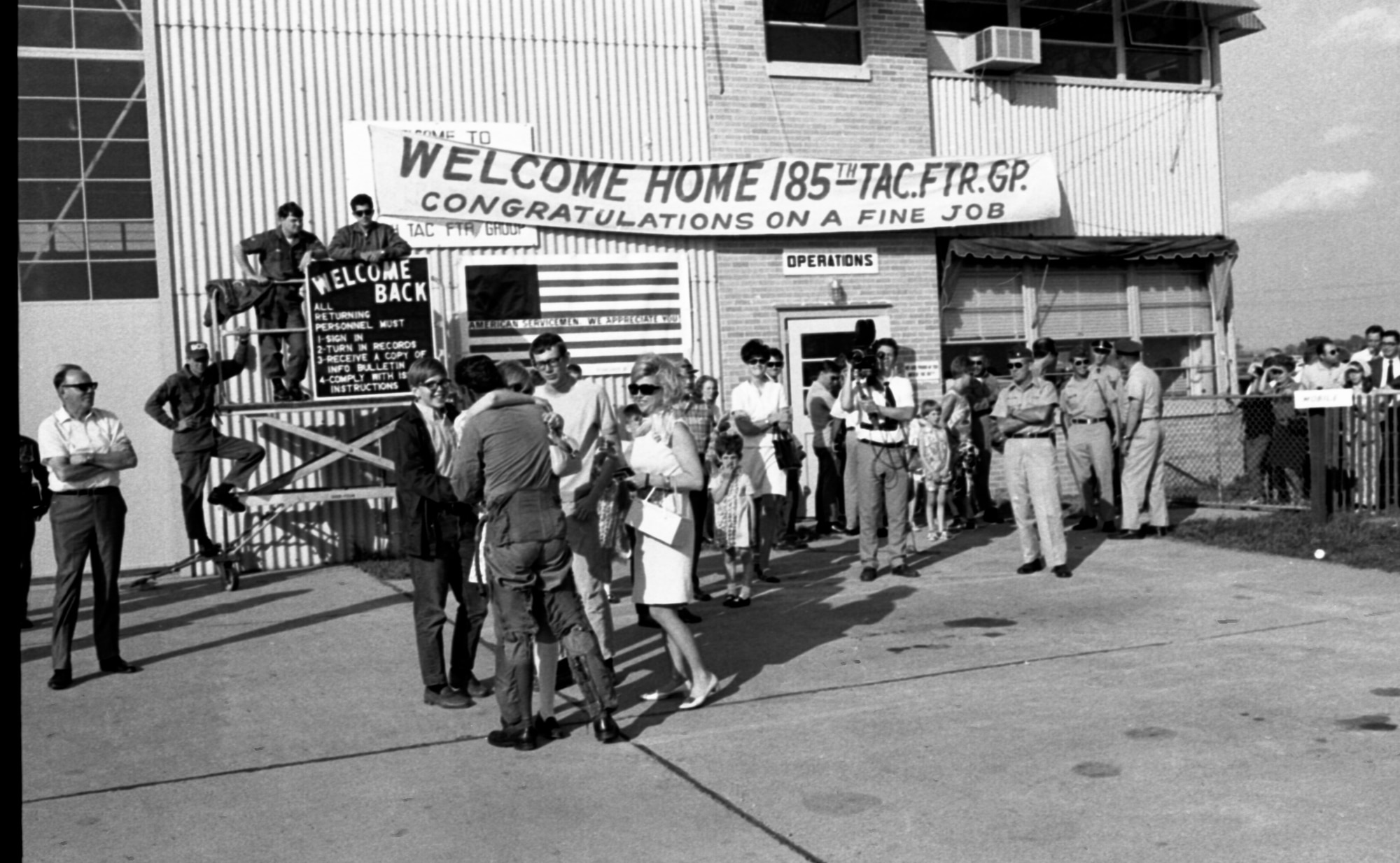 F-100 Pilots assigned to the 185th Tactical Fighter group are greeted by family members and well-wishers at the Air National Guard facility in Sioux City, Iowa on May 14, 1969 as they return from a yearlong activation at Phu Cat Airbase, South Vietnam. (U.S. Air National Guard photo/released 185th TFG Photo)