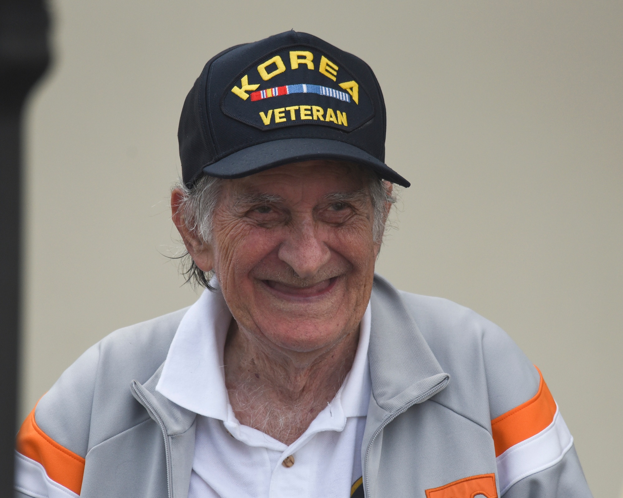 Eugene Downey, a U.S. Navy Korean War veteran smiles while watching 2017 Gulf Coast Salute on the Tyndall Air Force Base, Fla., flightline April 23, 2017. Downey enlisted in the Navy in 1948 and received the rank of ensign in 1951, enabling him to become a pilot. (U.S. Air Force photo by Senior Airman Solomon Cook/Released) 