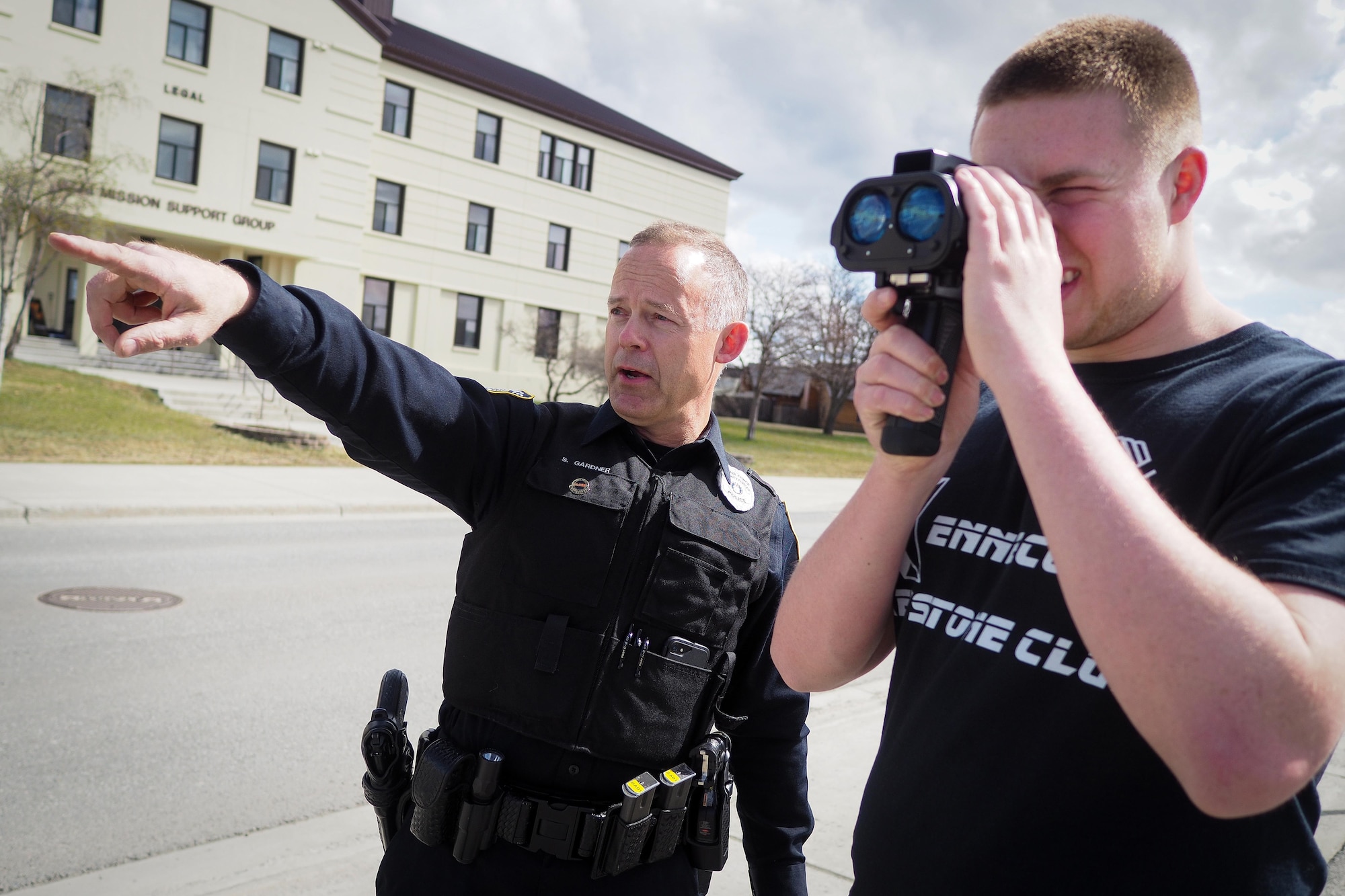 Bartlett High School student Aaron Regevig uses a light detection and ranging speed gun to accurately pinpoint the speed of a vehicle while Officer Scott Garner, Joint Base Elmendorf-Richardson civilian police officer trainer, educates Regevig on security-forces training on May 4, 2017.  Regevig is the son of Senior Master Sgt. Matthew Regevig from the 90th Aircraft Maintenance Unit. (U.S. Air Force photo/Justin Connaher)