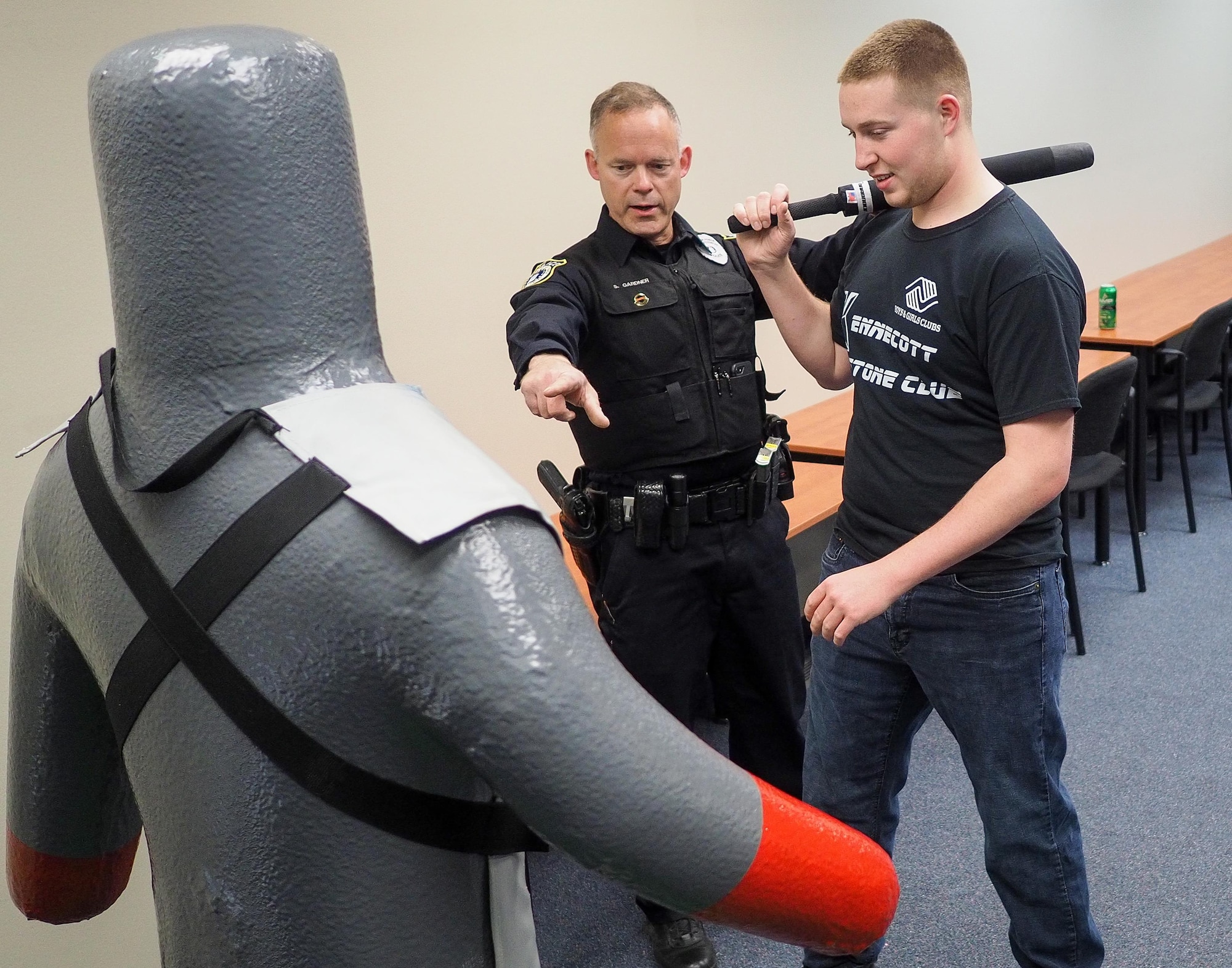Officer Scott Garner, Joint Base Elmendorf-Richardson civilian police officer, shows Bartlett High School student Aaron Regevig how to strike a dummy with a training baton during a job-shadowing program, May 4, 2017. More than 25 students participated in the program. (U.S. Air Force photo/Justin Connaher)
