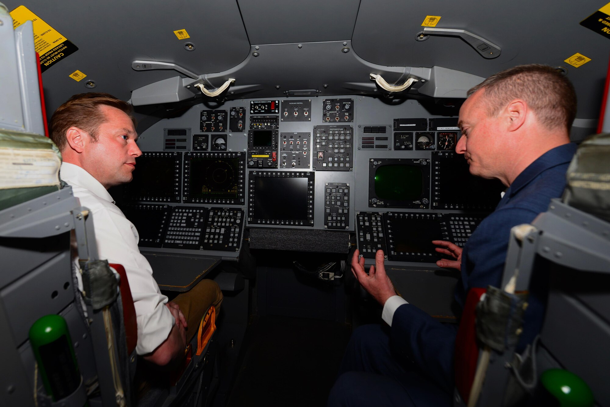 Dana Powell, the chief treaty officer for the 28th Bomb Wing, explains the role of a combat systems officer to Marcus Knuth, a member of the Danish parliament, in a B-1 Bomber simulator at Ellsworth Air Force Base, S.D., May 1, 2017. To keep updated with different situations that could occur while flying in the B-1, pilots and CSOs routinely simulate aerial missions. (U.S. Air Force photo by Airman 1st Class Donald Knetchel)