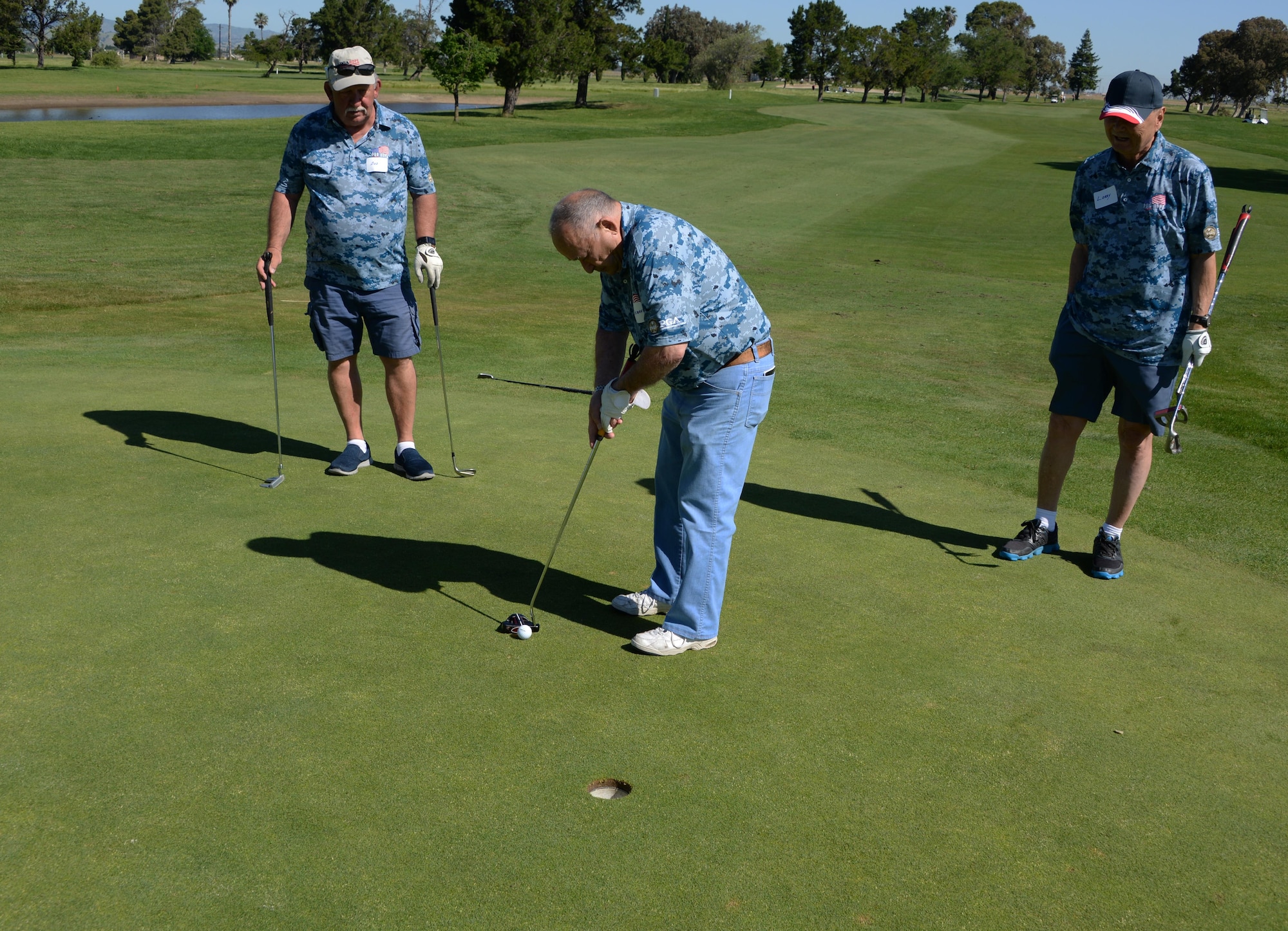 Sherman Standard, 91, a U.S. Navy veteran who served during WWII, prepares to make a put May 5 during the Professional Golfers Association's Helping Our Patriots Everywhere event at Cypress Lakes Golf Course in Vacaville, Calif. Dozens of veterans attended the event designed to teach golf skills and bring prior service members together. (U.S. Air Force photo/Tech. Sgt. James Hodgman/Released)